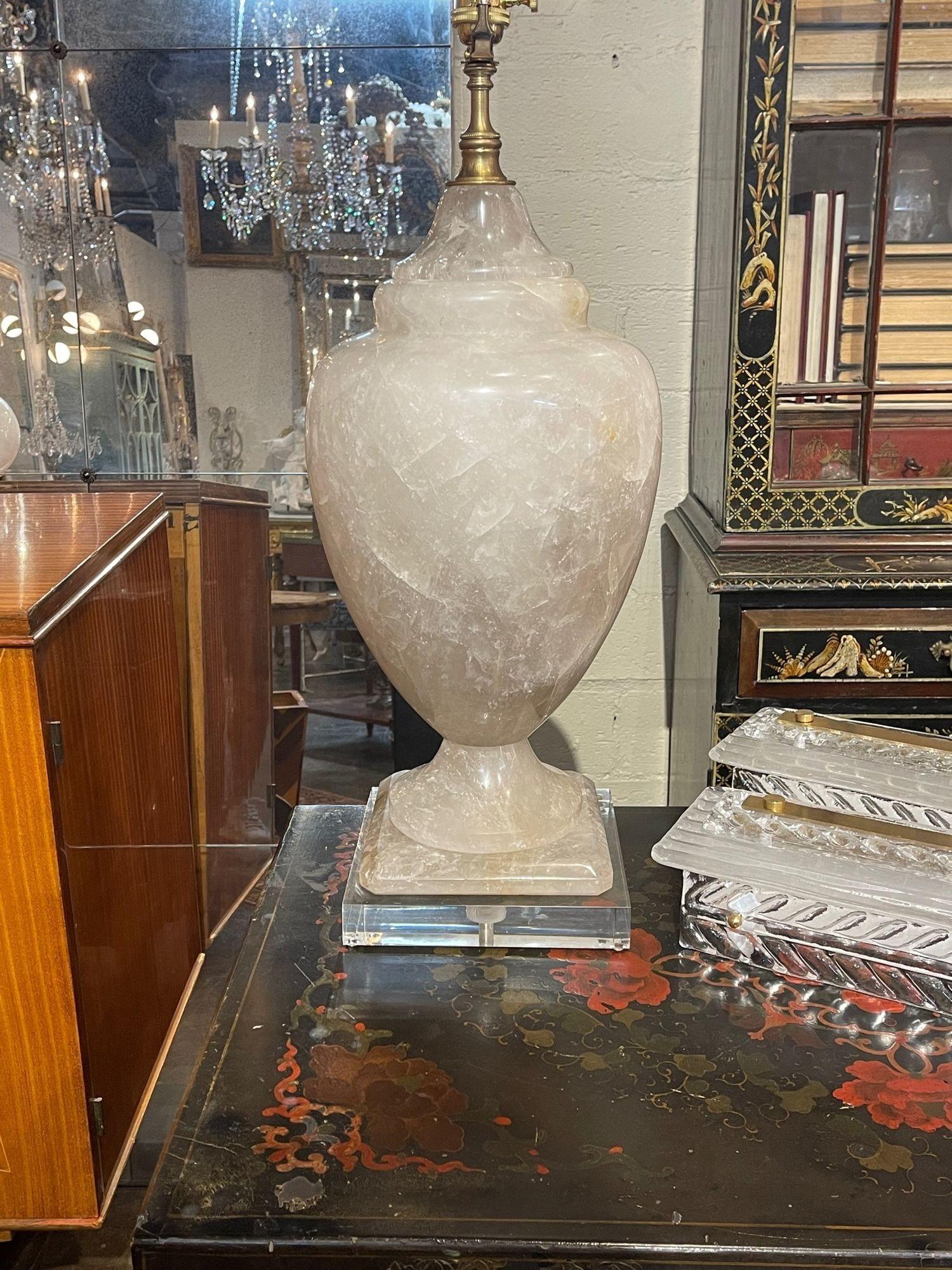 Very fine large scale polished rock crystal lamp from Brazil. Beautiful urn shape on a lucite base. Creates a very elegant touch! So impressive!