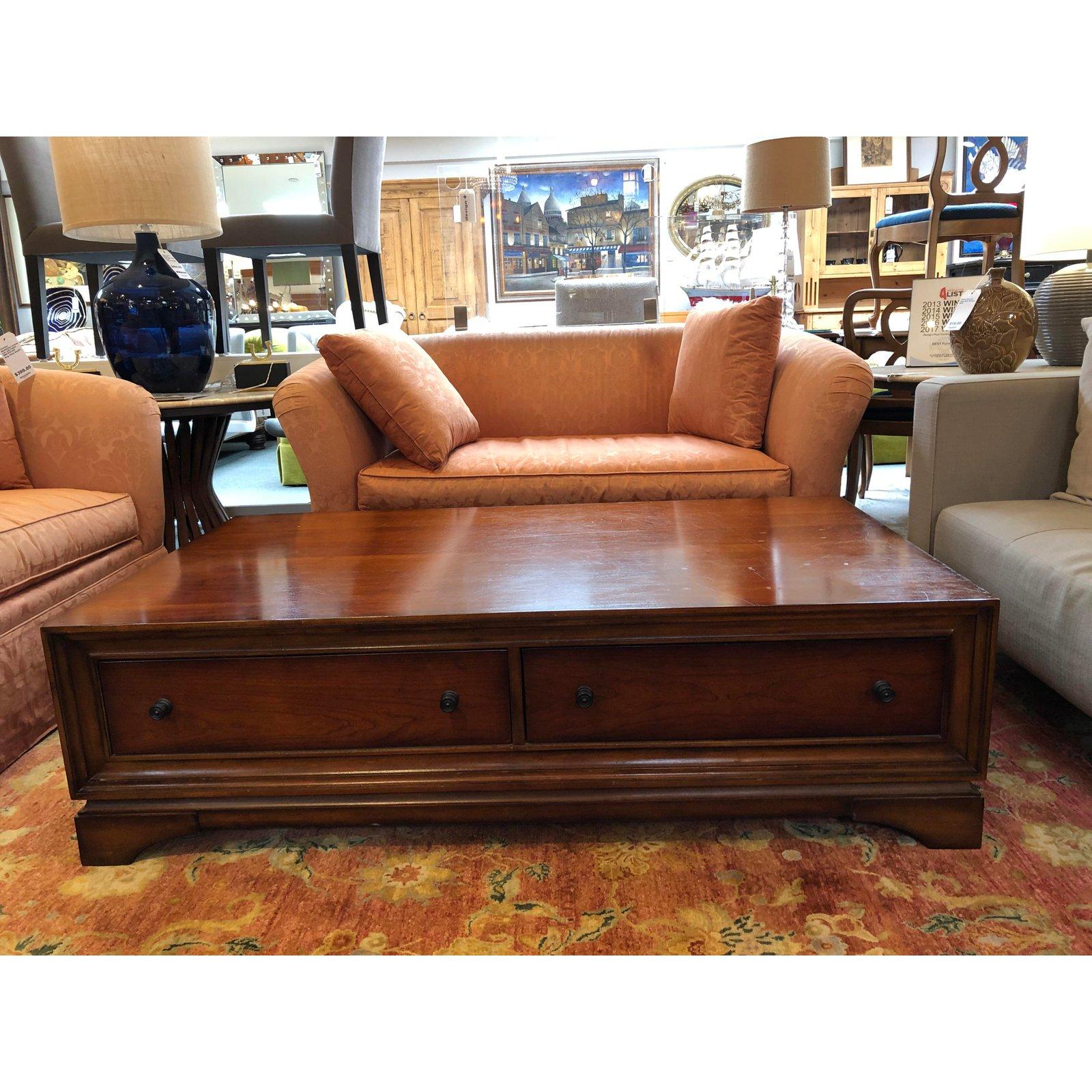 The Portman coffee table by Restoration Hardware. Featuring Classic details such as rich woodgrain, panel panels and bronze pulls, this large cocktail table offers two deep drawers for storage. Two drawers fronts are for visual balance