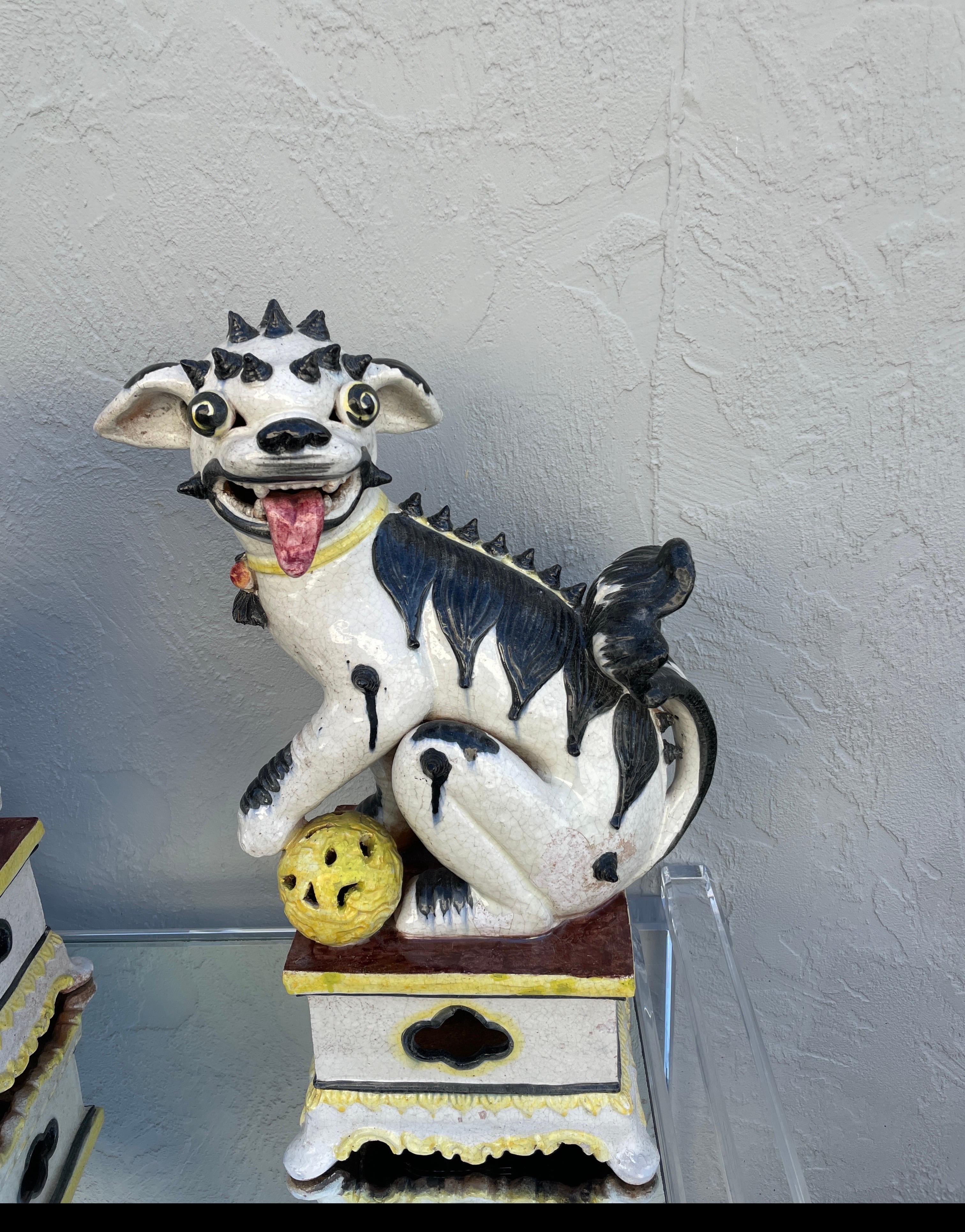 Vintage pair of wonderful Italian mid-century foo dogs. Predominately black, white and yellow in colorations. A very rare and unique pair.