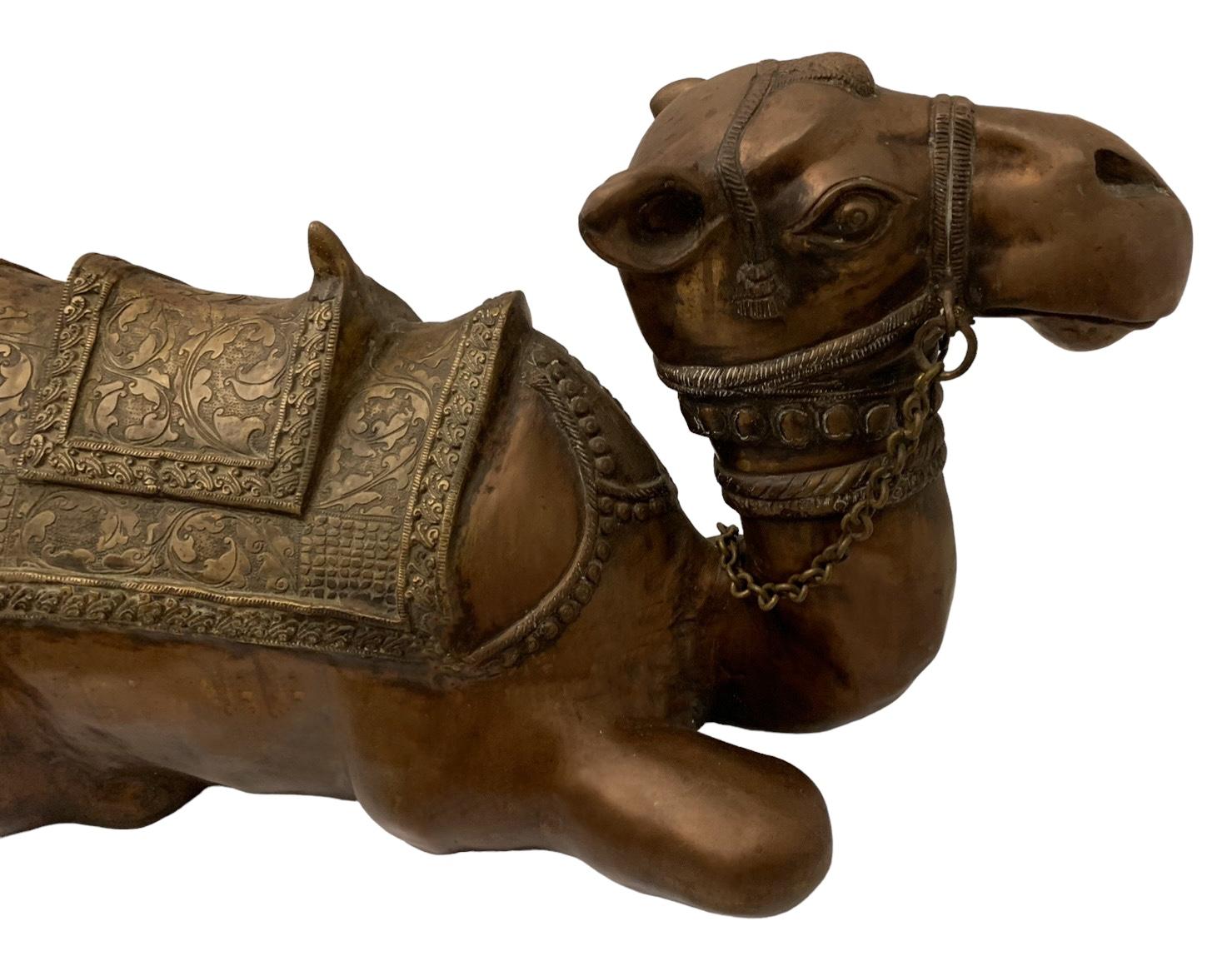This is a large scale cast bronze Moorish style camel with brass repousse blanket attributed to Maitland - Smith. It is unmarked and has some age appropriate patina. 