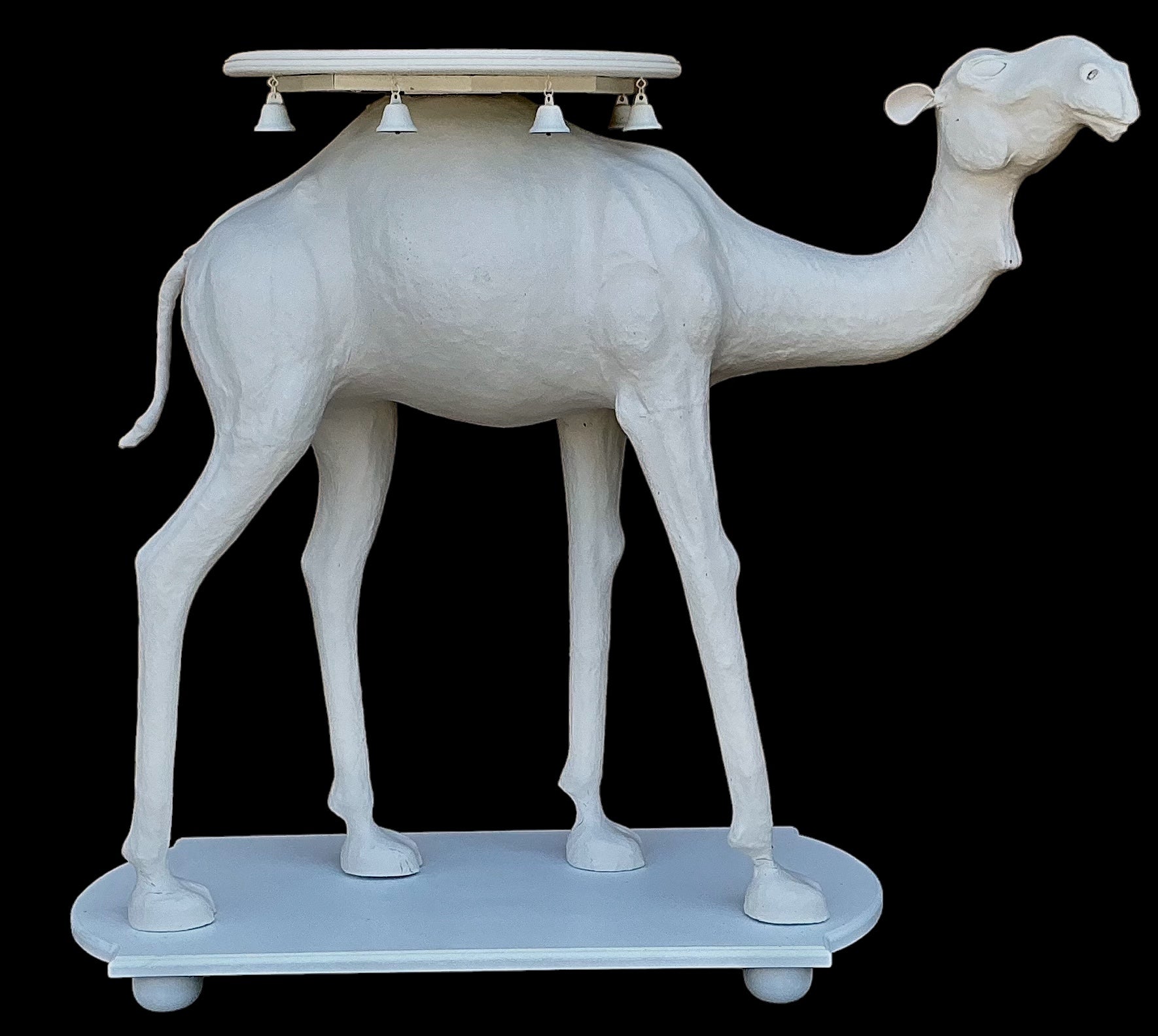 This is such a fun table! It is a large scale Regency style camel form side table. This is a mid-century find. The carved and pierced top is most likely teak. The base is poplar. The body is leather with glass eyes. It is in very good