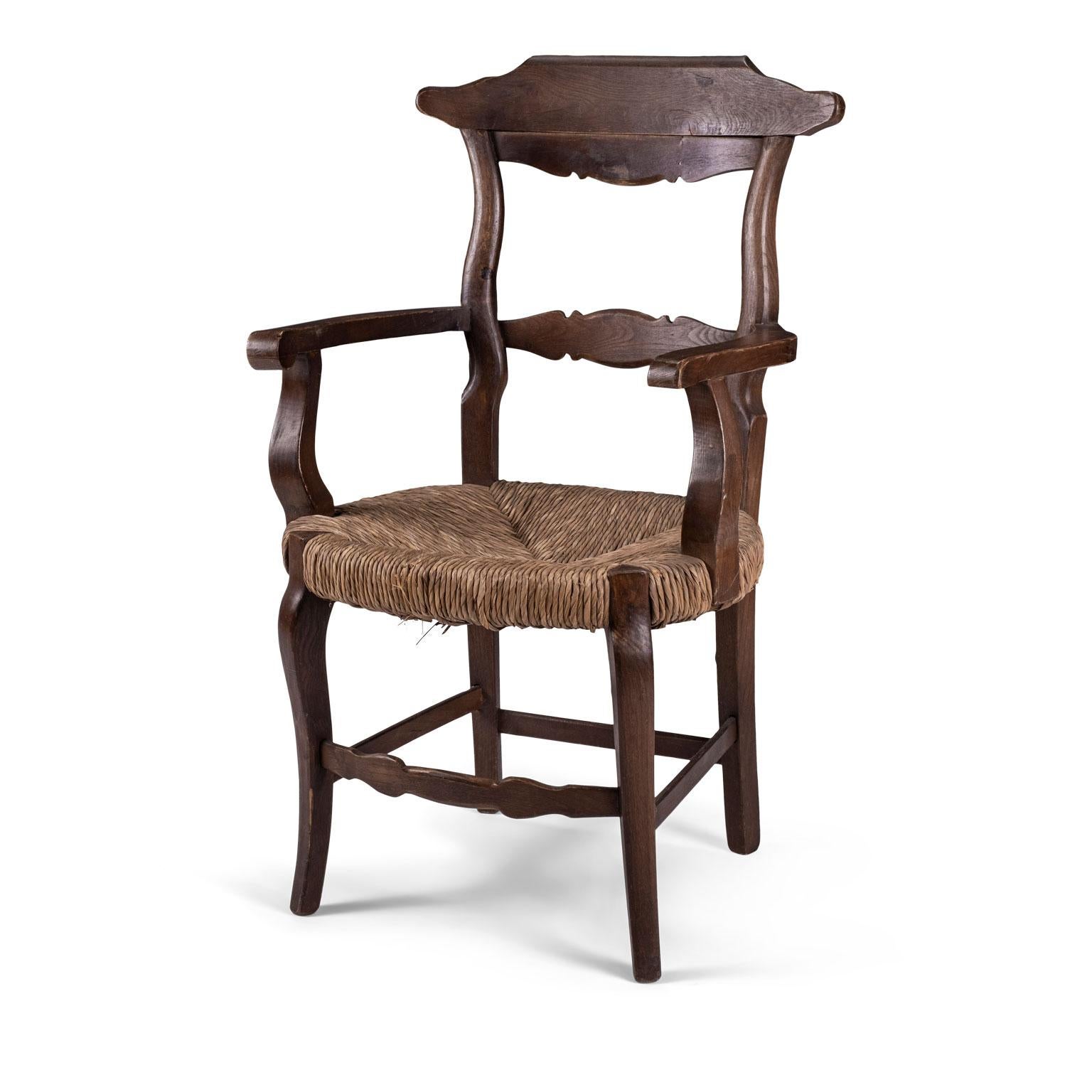 Large scale rustic rush-seat French chair, circa 1920-1950. Generous proportions with wide original rush seat. Well-made, comfortable and sturdy. Seat measures: 18 inches high x 18 inches wide x 20 inches deep and arms are 27 inches high.