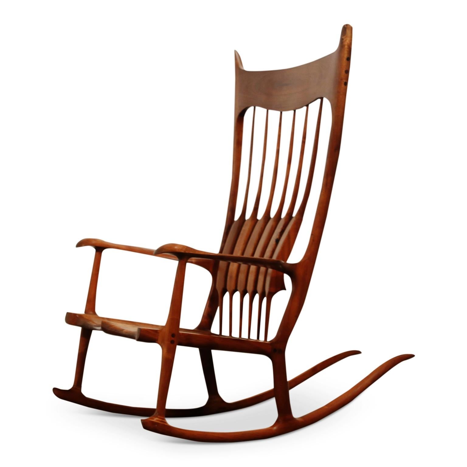An incredibly stunning large scale studio rocking chair by Charles Jacobs, signed and dated 11-8-85. 

This monumental Sam Maloof style craftsman chair was handcrafted with solid, heavily grained, hardwood, which was expertly finished with generous