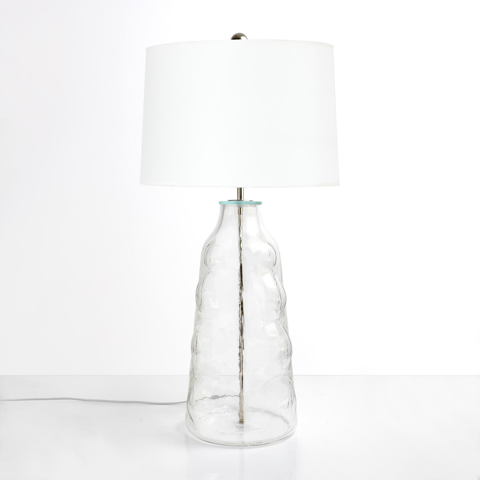 A large-scale Scandinavian Modern clear glass table lamp with raised circular design. Newly rewired with high quality nickel plated double cluster sockets and silk cord. Made by Flygsfors, Sweden, circa 1960.

Measures: Height 32”, diameter 9”.