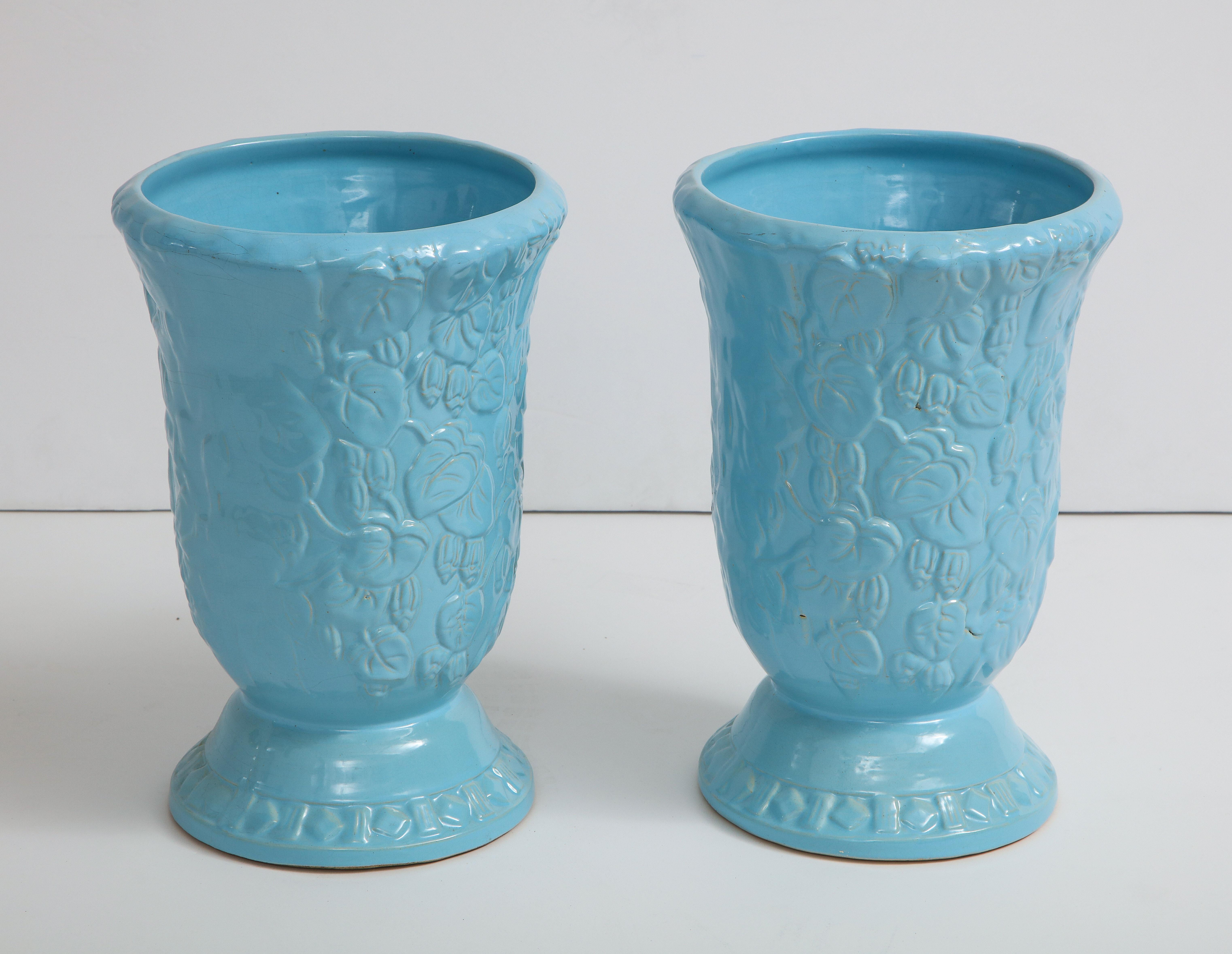 Exquisite pair of large scale cache pots featuring an all-over leaf and vine raised pattern and a refreshing sky blue glaze. New old stock, Roseville, circa 1930s.
