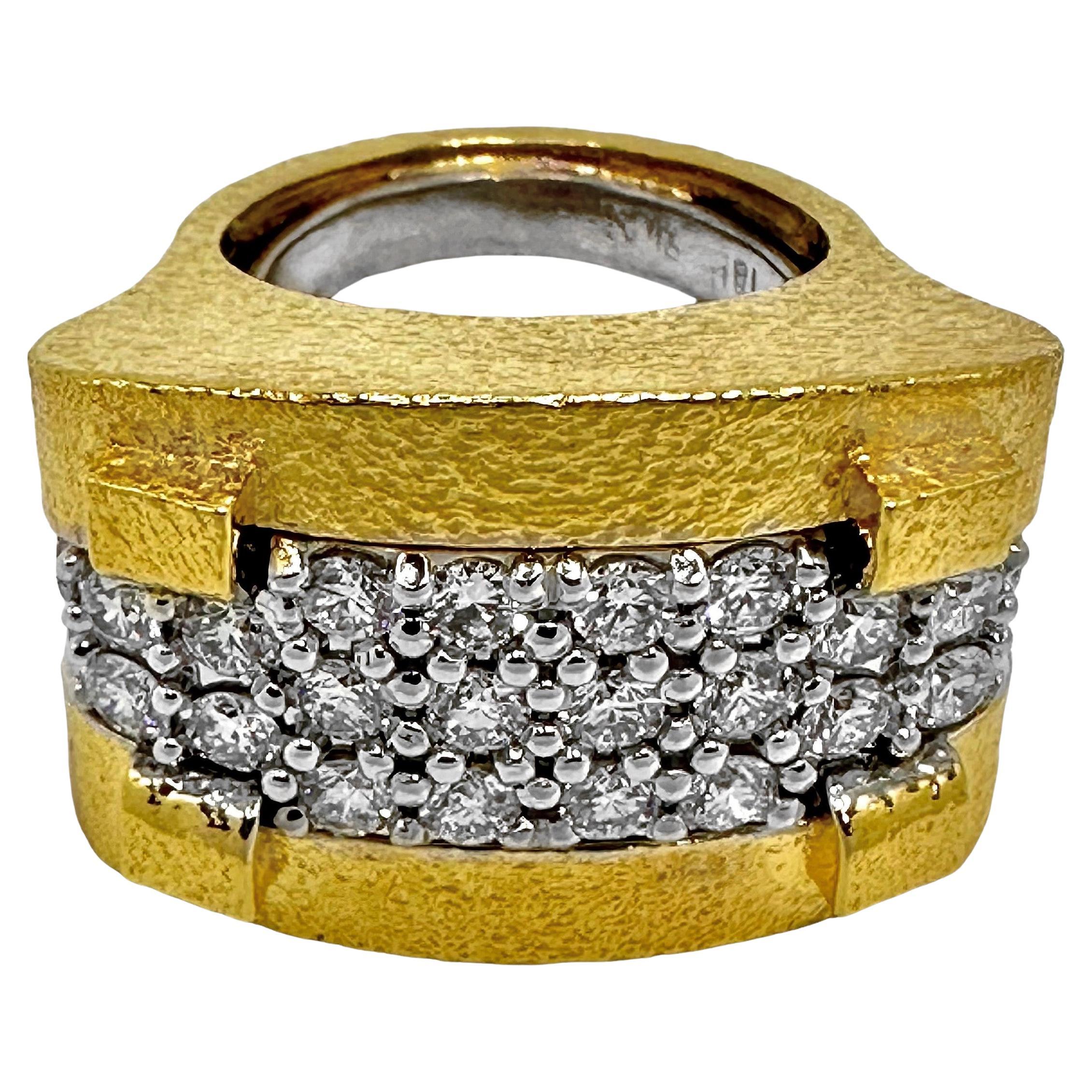 This crisp and intriguing 18K yellow gold, platinum and diamond architectural ring was manufactured in our own shop and to extremely high standards. The ring measures a full one inch in length, 3/4 inches in width and is intricately hammer finished