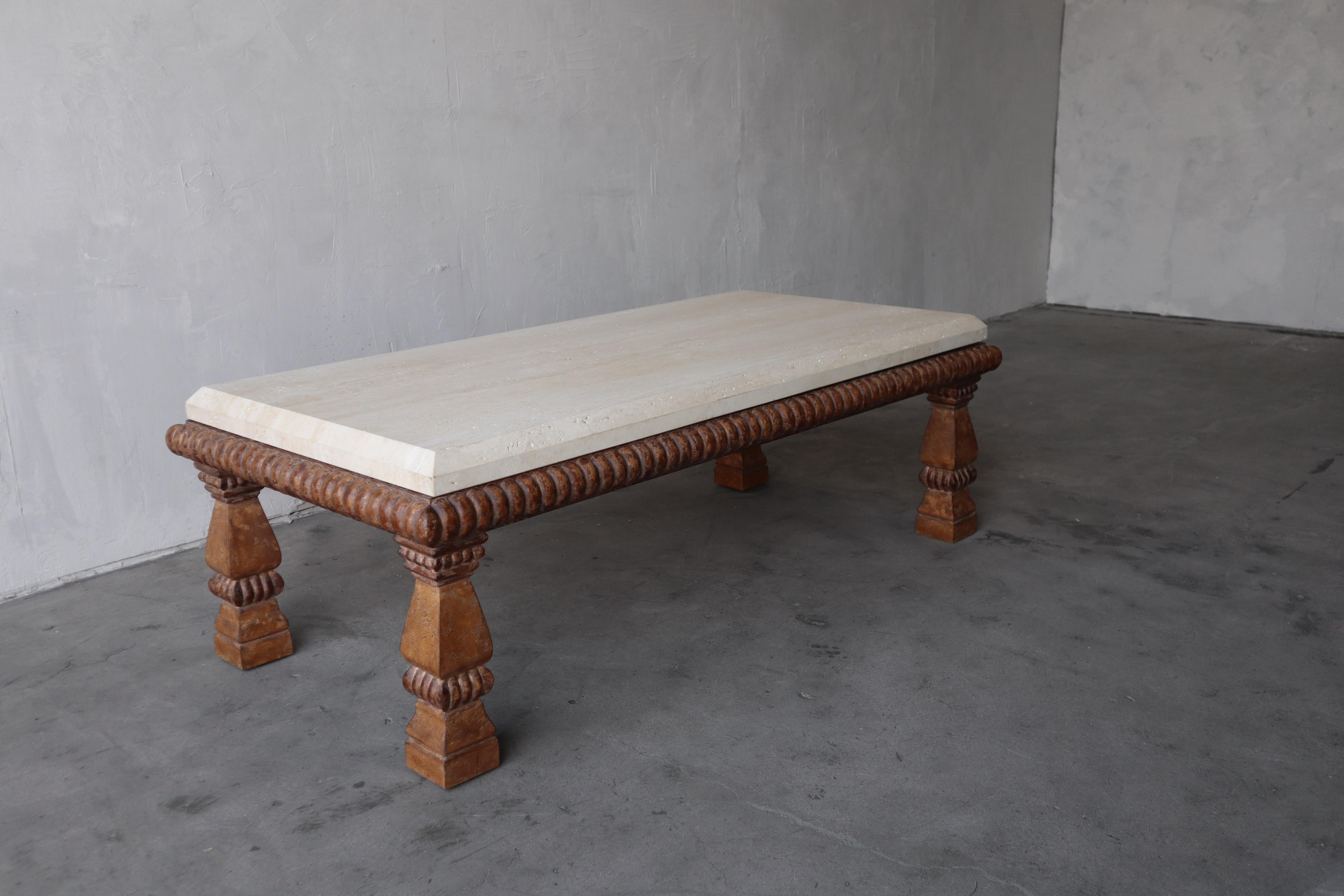 A gorgeous table by Luxury Furniture brand Kreiss. Known for their craftsmanship and beautiful designs, this carved wood and travertine coffee table is no exception. A solid travertine top sit on a cerused and lightly distressed, carved wood