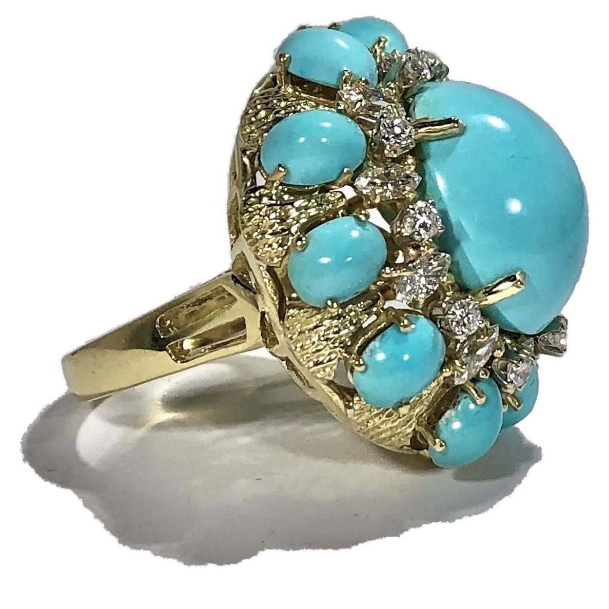 A beautifully crafted large scale, 18K yellow gold cocktail ring featuring a high polished shank and shoulders, with 10 bark finished panels. In the center is 
one oval cabochon turquoise measuring 18mm X 14mm. Surrounding the center turquoise are