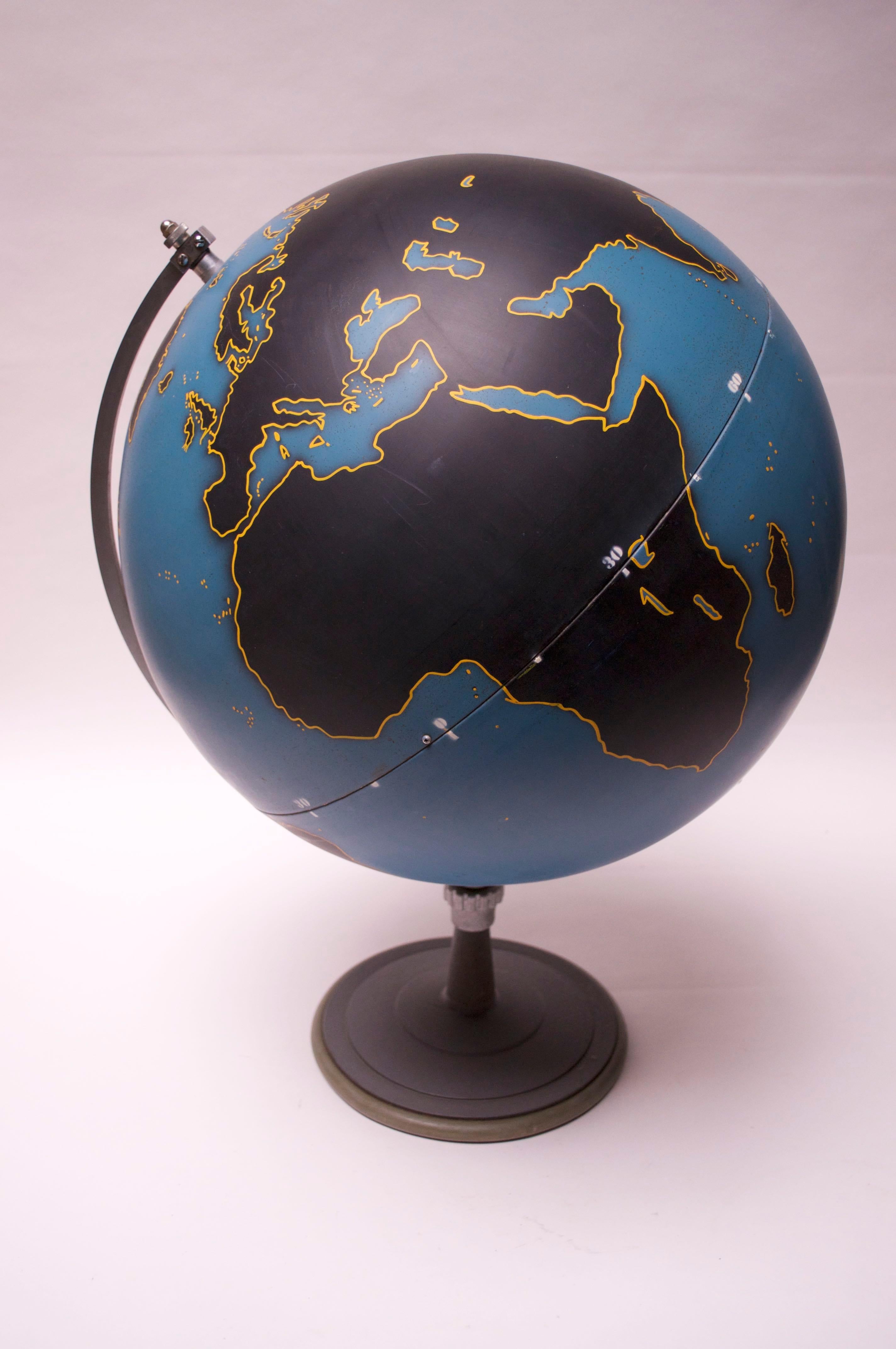 Machine Age-style Denoyer Geppert of Chicago Military or Activity Globe composed of a spun metal blue orb with black slated land masses outlined in yellow. These globes were used by the military and NASA, in addition to serving as geographical