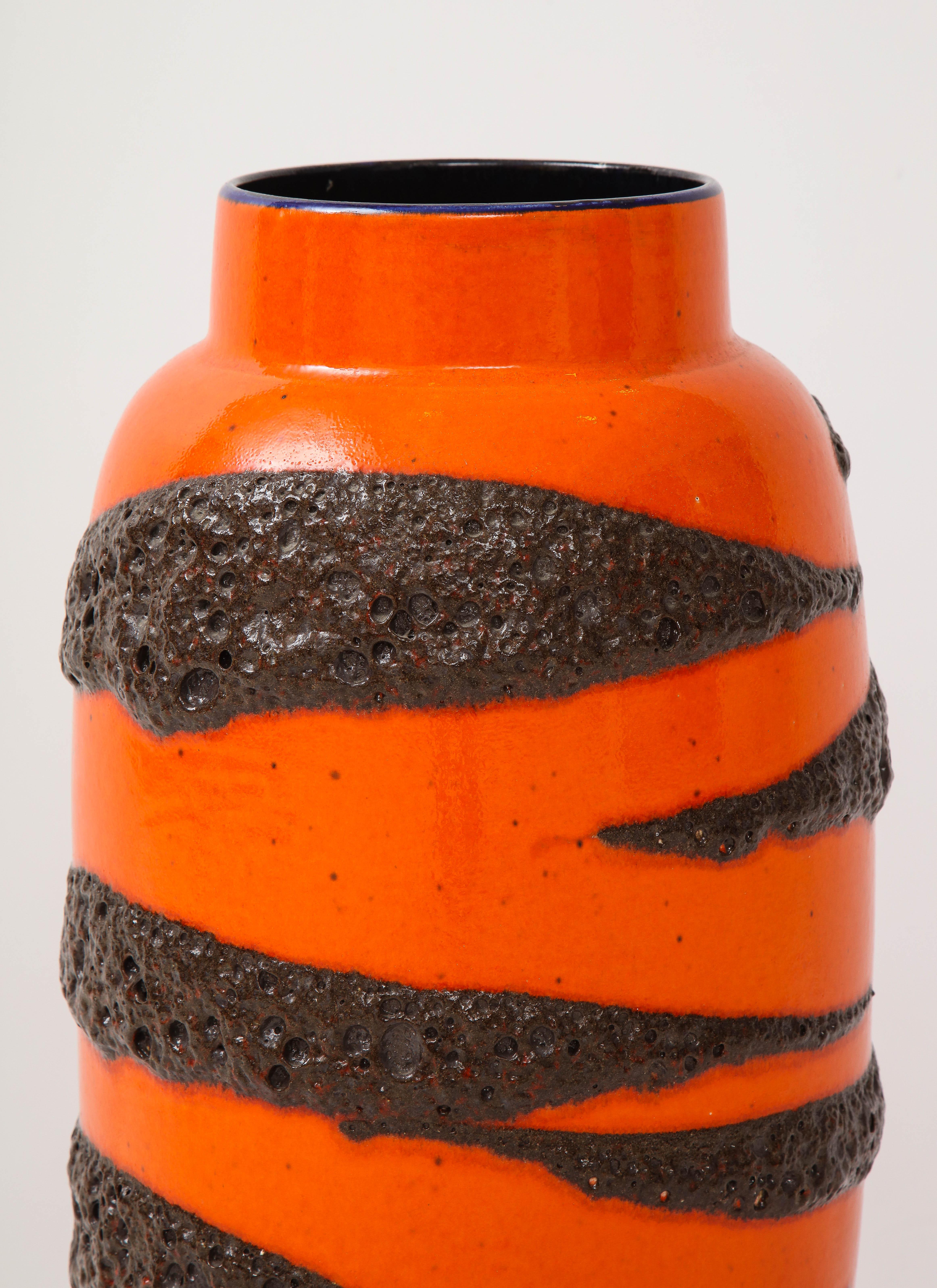 Large orange glazed ceramic vase with lava textured design and cobalt blue interior glazing. Marked on bottom : W Germany, numbered 553-52.
  