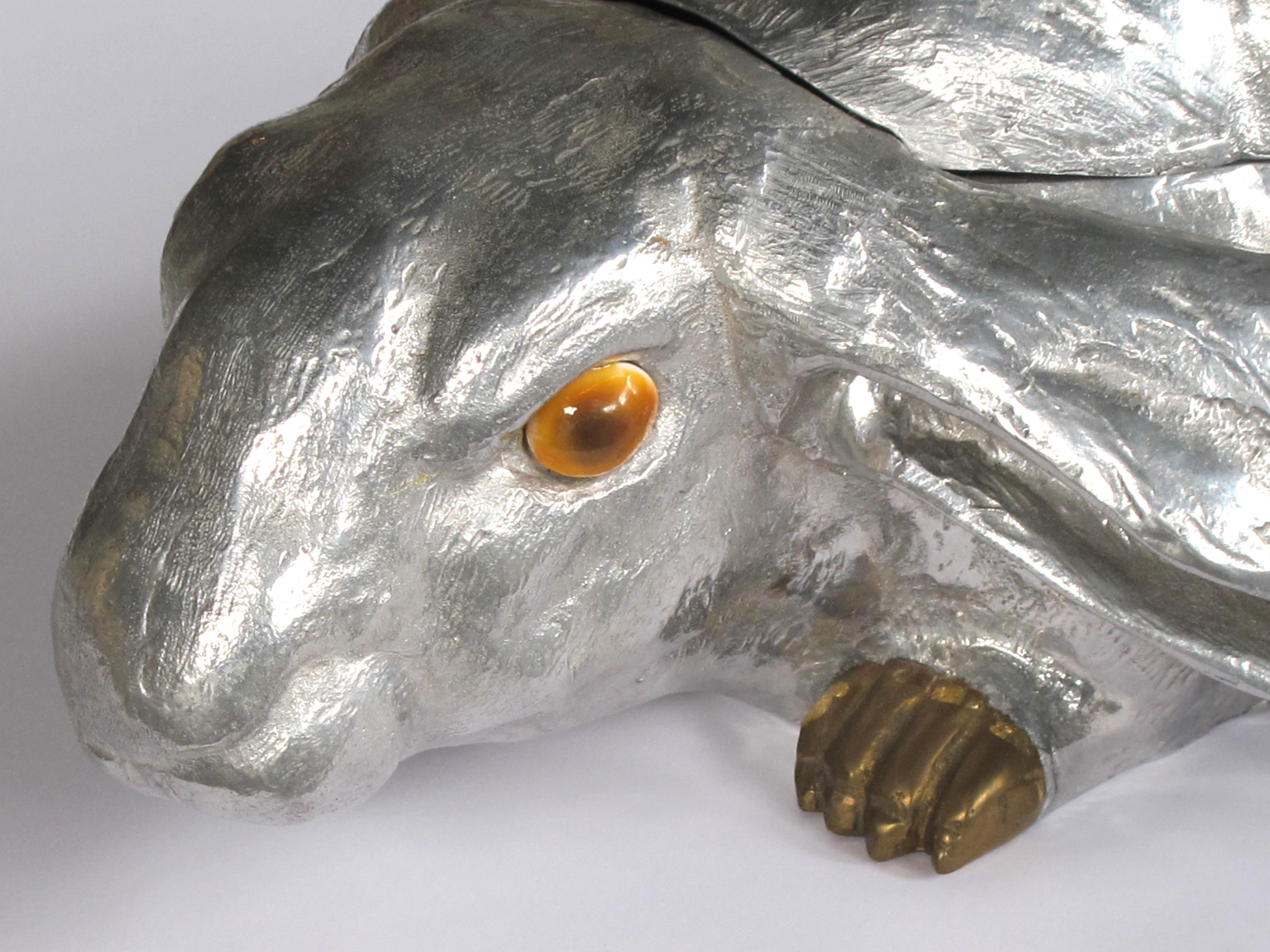 A delightful and large-scaled American polished aluminum and brass rabbit wine cooler/ice bucket by Arthur Court, San Francisco; this life-sized rabbit made of polished aluminum with brass feet and carnelian eyes; the top half is a hinged lid;