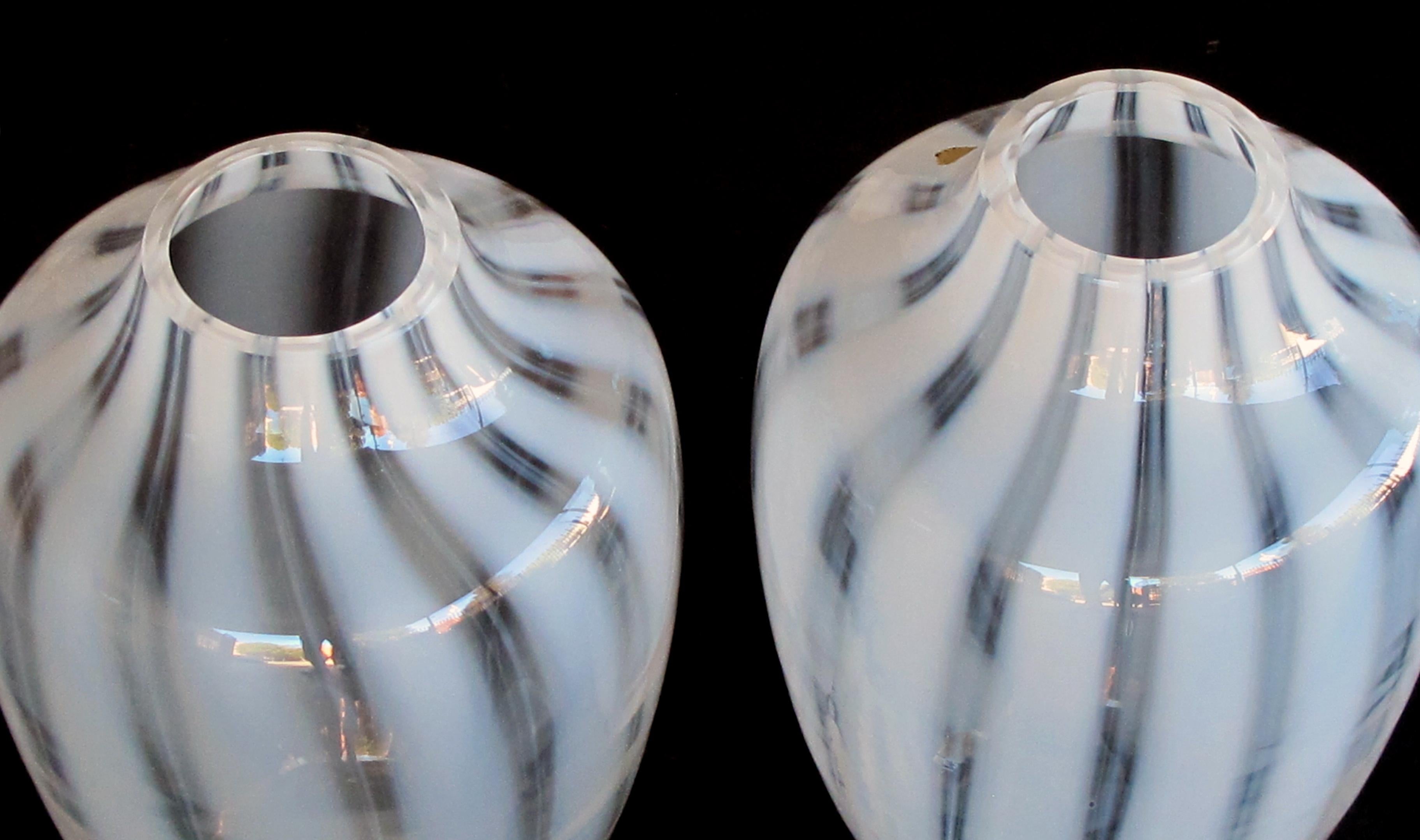 A large-scaled and striking pair of Hessen Glaswerke midcentury white striated ovoid vases (West Germany); each tall vase of ovoid form with short neck above an ovoid body; the luminous glass with subtle white streaking; with foil labels.