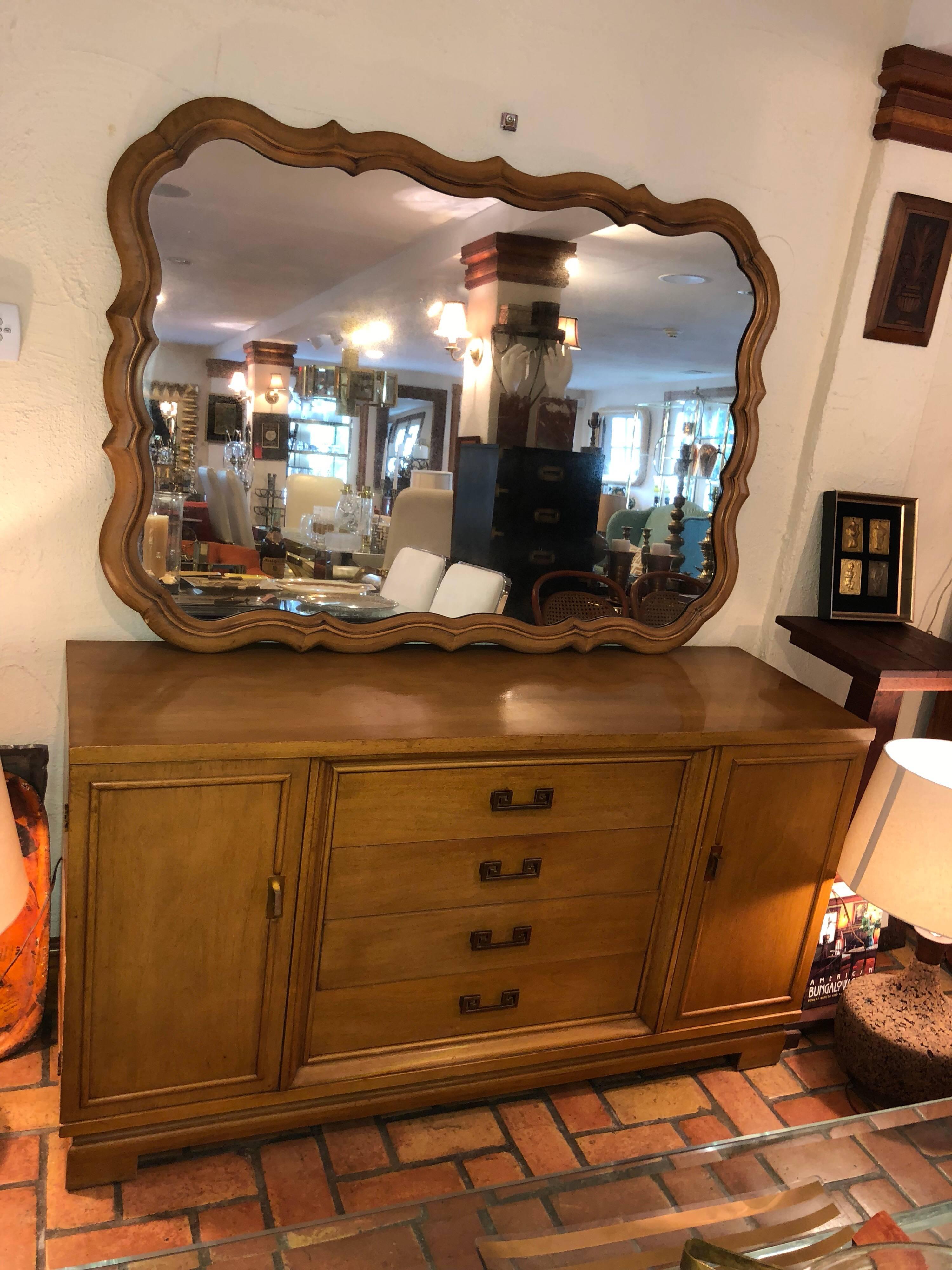 Large scalloped fruitwood mirror. Solid wood construction . It looks gorgeous above our matching wooden Henredon credenza. They match perfectly. The mirror has a slight smoky finish to the glass.  This is intentional. Please inquire about dealer