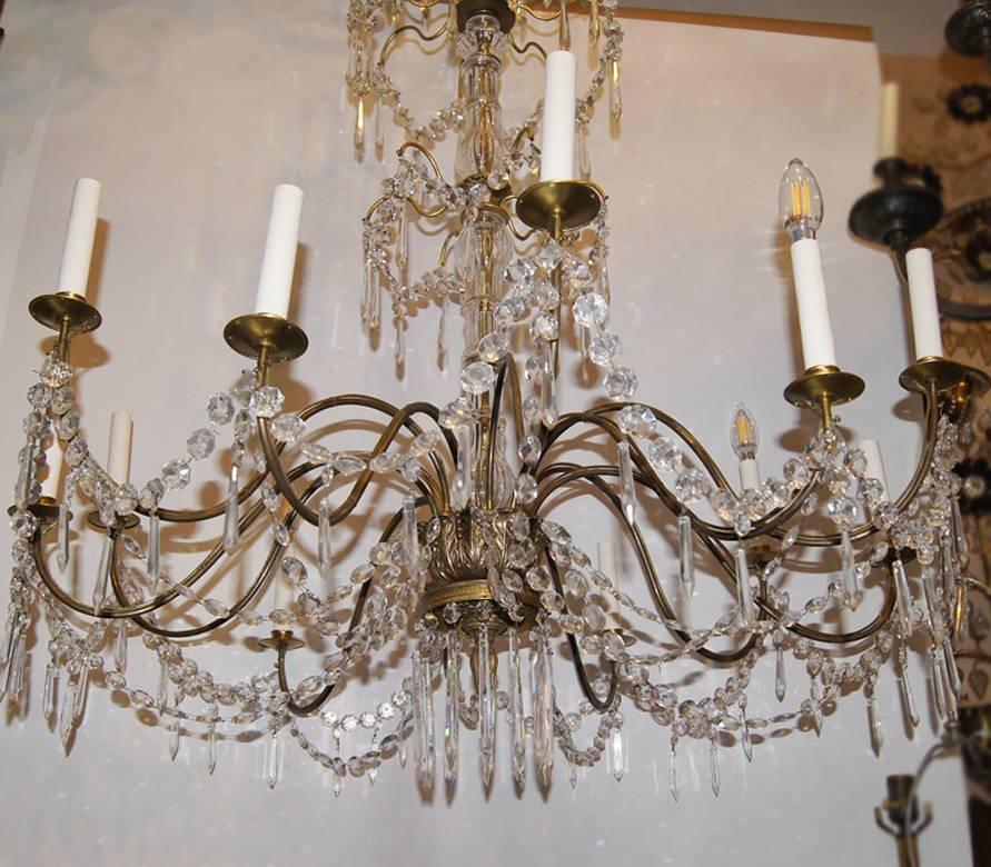 A circa 1900 Swedish gilt chandelier with crystal drops and 12 lights.