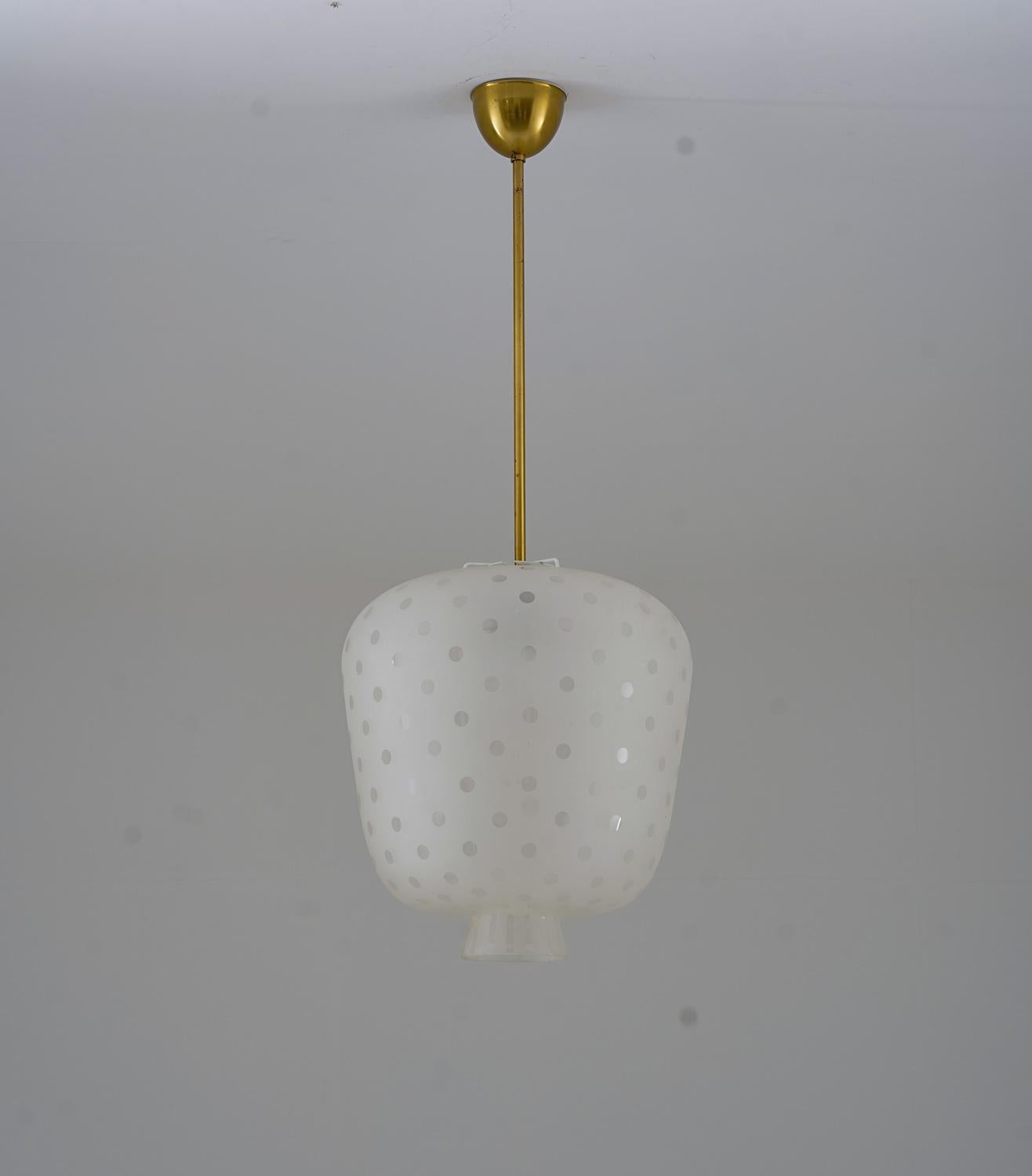 This pendant is a notable example of Swedish craftsmanship from the 1940s. Its large size and distinctive design make it a captivating piece. The pendant is made of blasted glass, which lends it a unique texture and appearance.

The lamp features