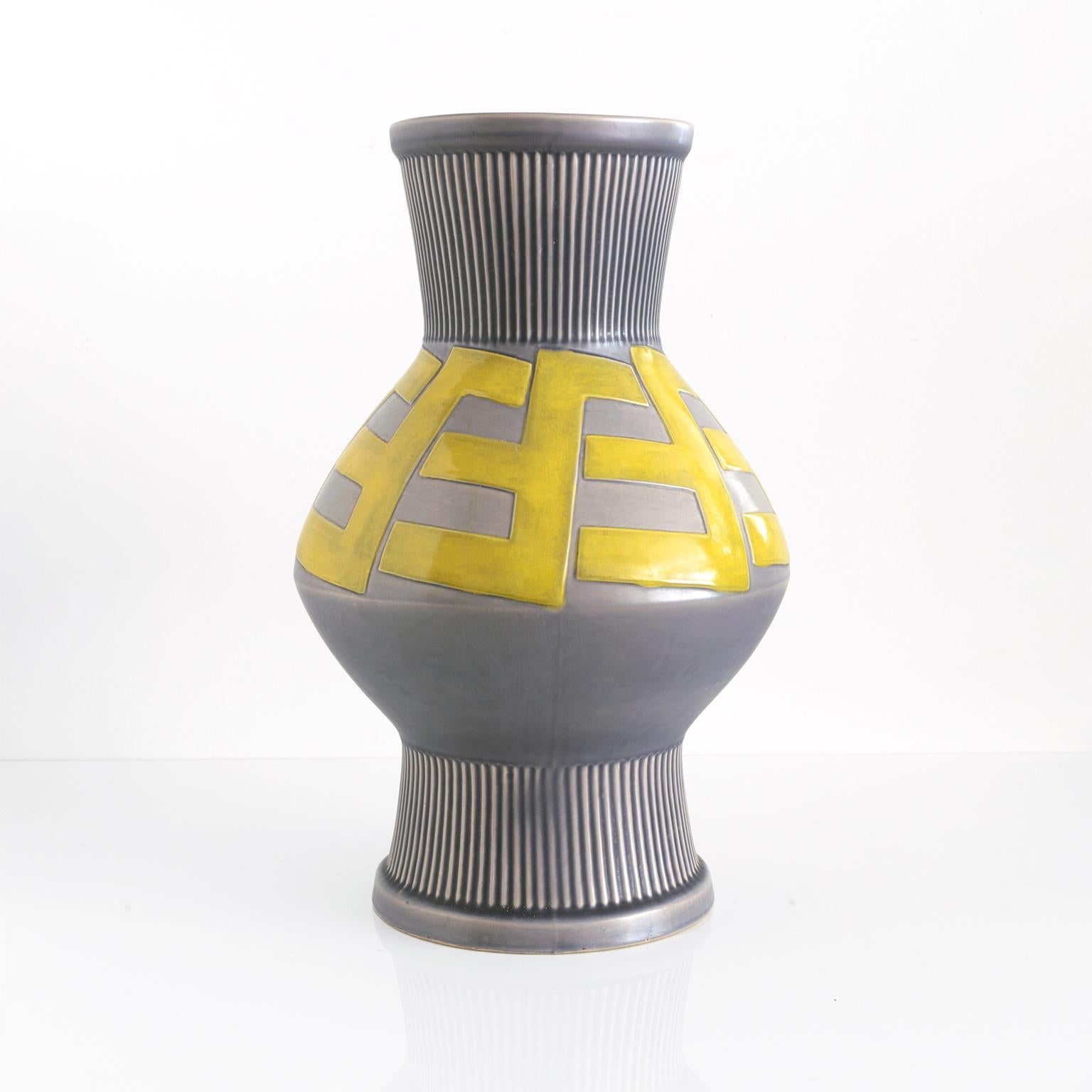Large Swedish Art Deco ceramic vase with a raised bold pattern in a golden glaze on a grayish blue background. Designed by artist Ewald Dahlskog for Bo Fajans circa 1930's. Measures: Height 17.5