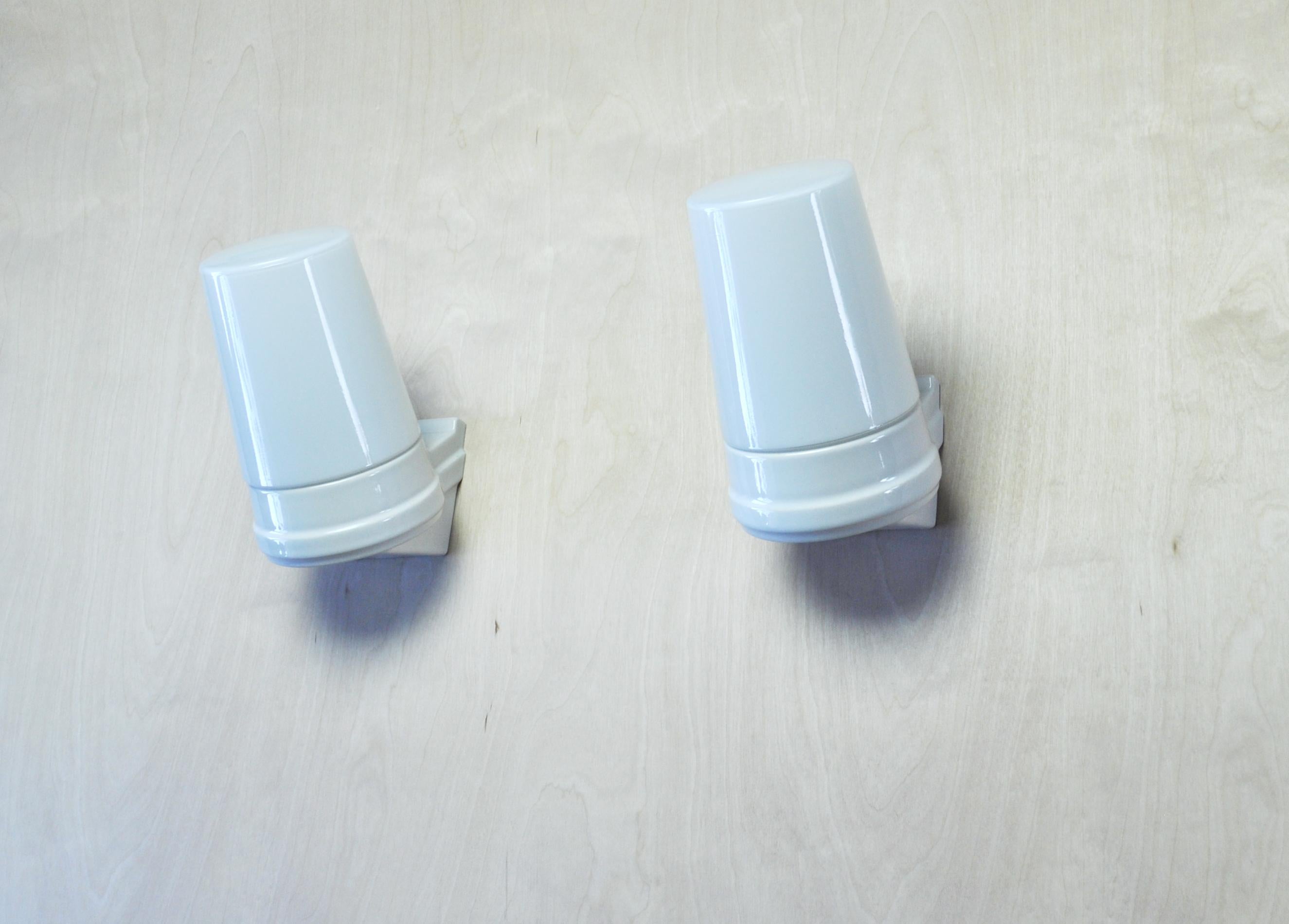 Set of 2 large Scandinavian Modern white glazed porcelain combined with two milky white opaline glass design by Sigvard Bernadotte for IFÖ, Sweden 1960s. 
Light source: E27 Edison screw fitting max 75W. Made for wet areas such as bathrooms, but