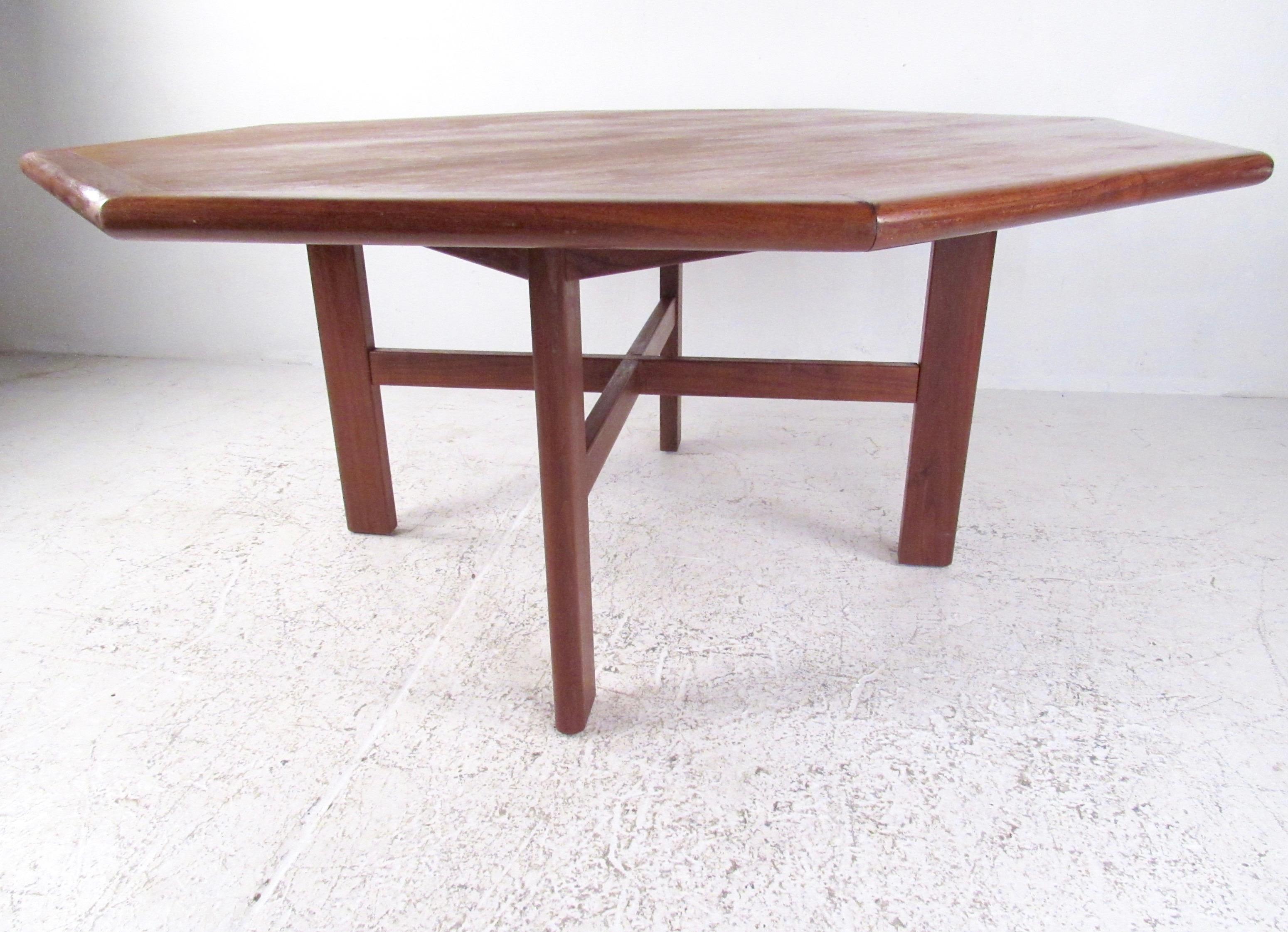 Large octagonal teak dining table features sturdy hardwood construction and striking vintage teak finish. Impressive Mid-Century Modern design makes this Scandinavian modern teak table a substantial addition to home or business dining or meeting