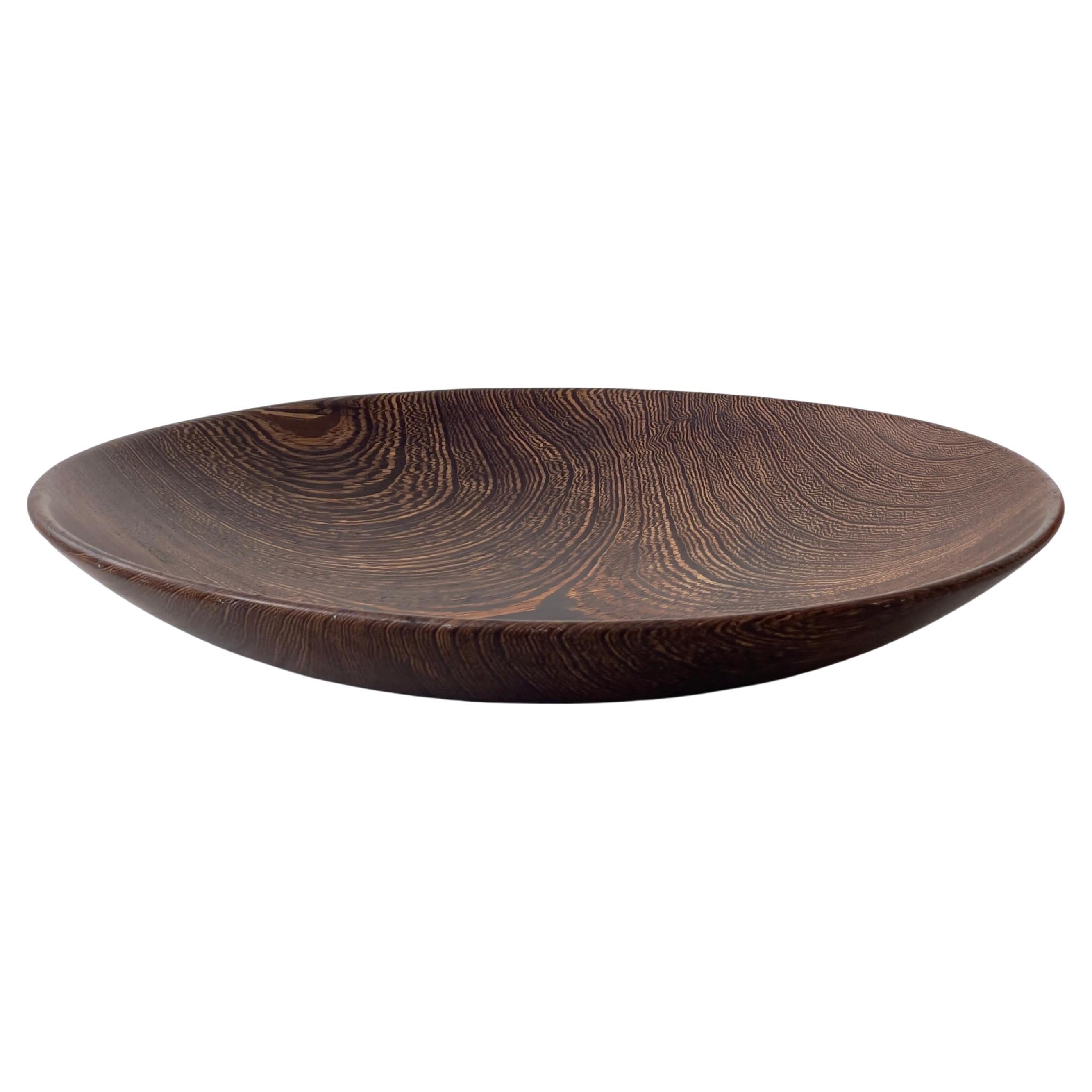 Large scandinavian serving bowl in hand carved dark hard wood. Finland 1960s.
