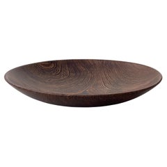 Large scandinavian serving bowl in hand carved dark hard wood. Finland 1960s.