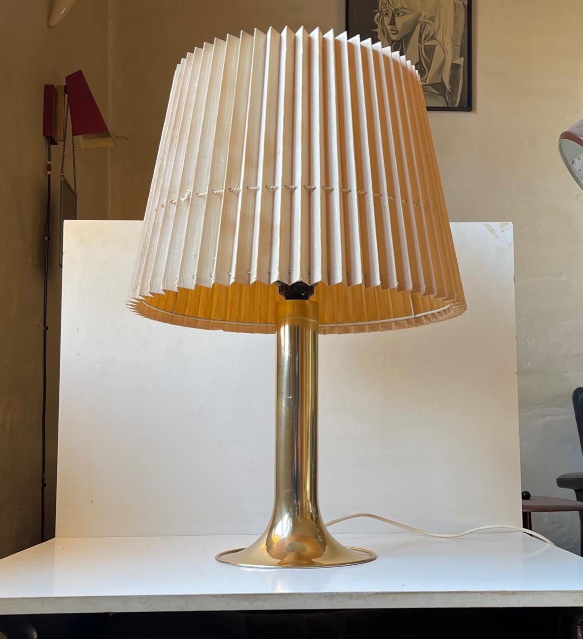 A large trumpet shaped table light executed in brass-alloyed aluminium. Manufactured by Fog & Mørup in Denmark circa 1970 in association with the Silhuet pendant lamp series by Jo Hammerborg. This lamp was only made for one year and was redrawn