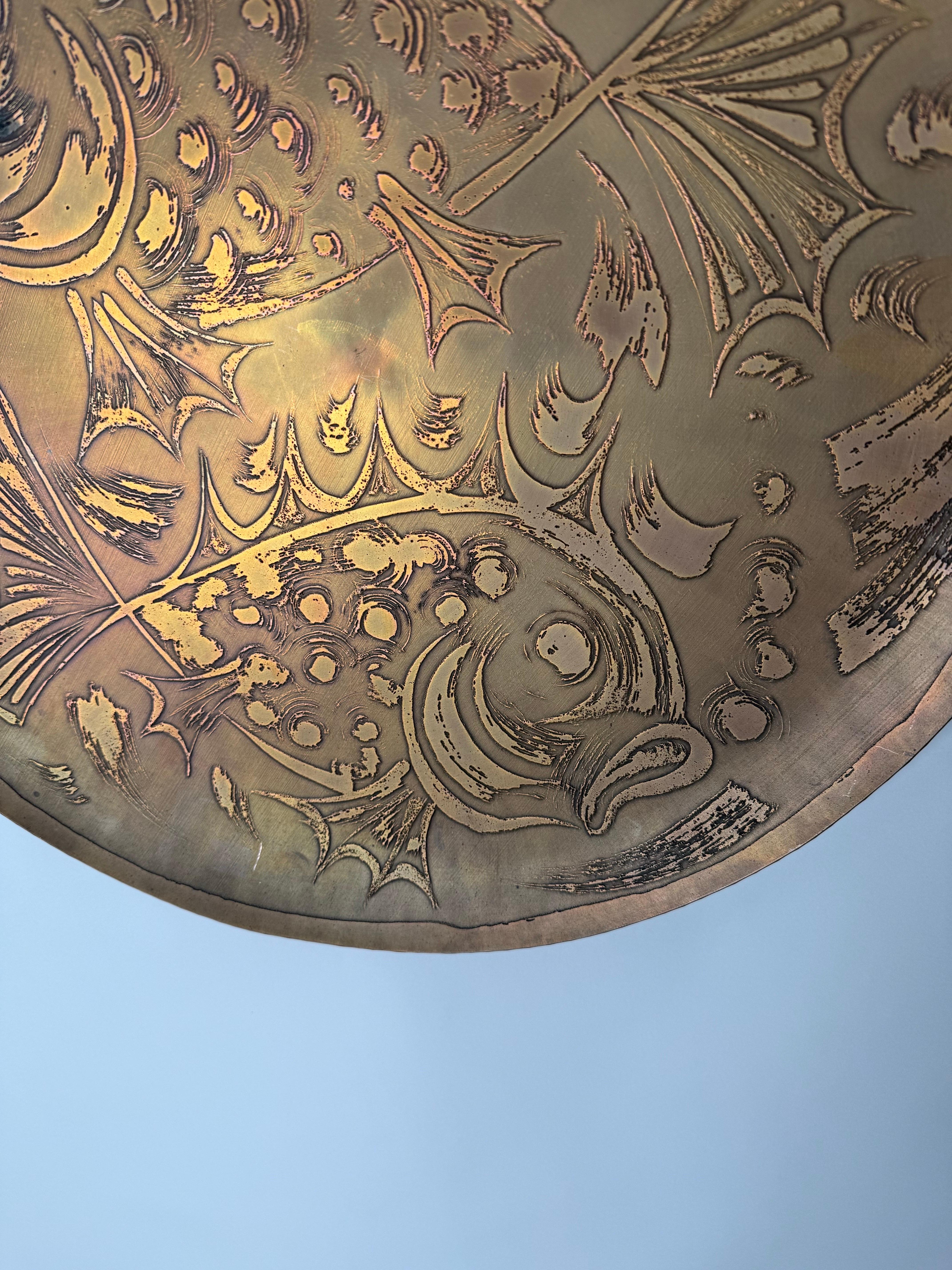 Exclusive copper wall decoration. This wall plate is a very rare work of art and the perfect decoration for your home. The fish were applied in relief to the plate using an elaborate etching technique; the artistic achievement is perfect. Anyone