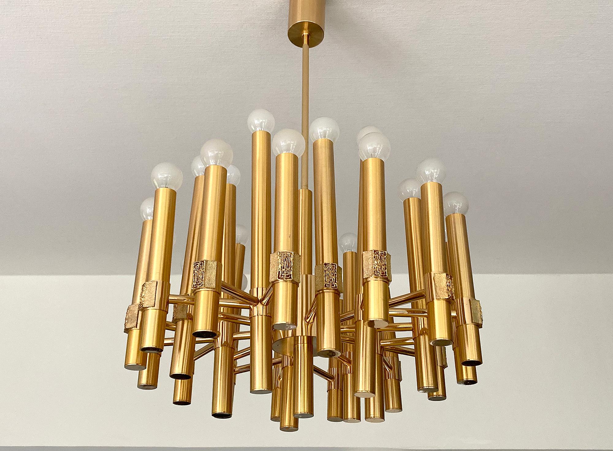 Impressive chandelier by Gatetano Sciolari , brass structure with ramificated 20 spokes, brutalist ornamentation on each of the 
end pieces, the spokes in the second row are slightly leaned outward 
Dimensions:
31.5 in. / 80 cmH (total