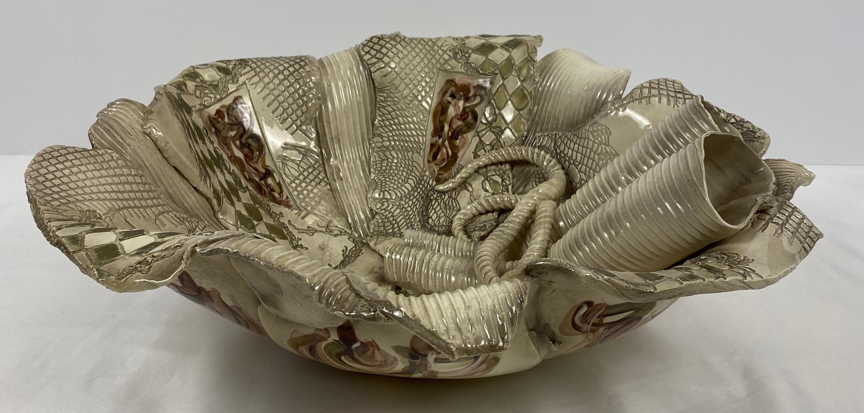 A large, unique and stunning ceramic bowl by American ceramic artist Gail Markiewicz.

The glazed vessel by Gail Markiewicz features her iconic design of interlinked textures and carvings into a patchwork clay quilt, arranged in rows of and