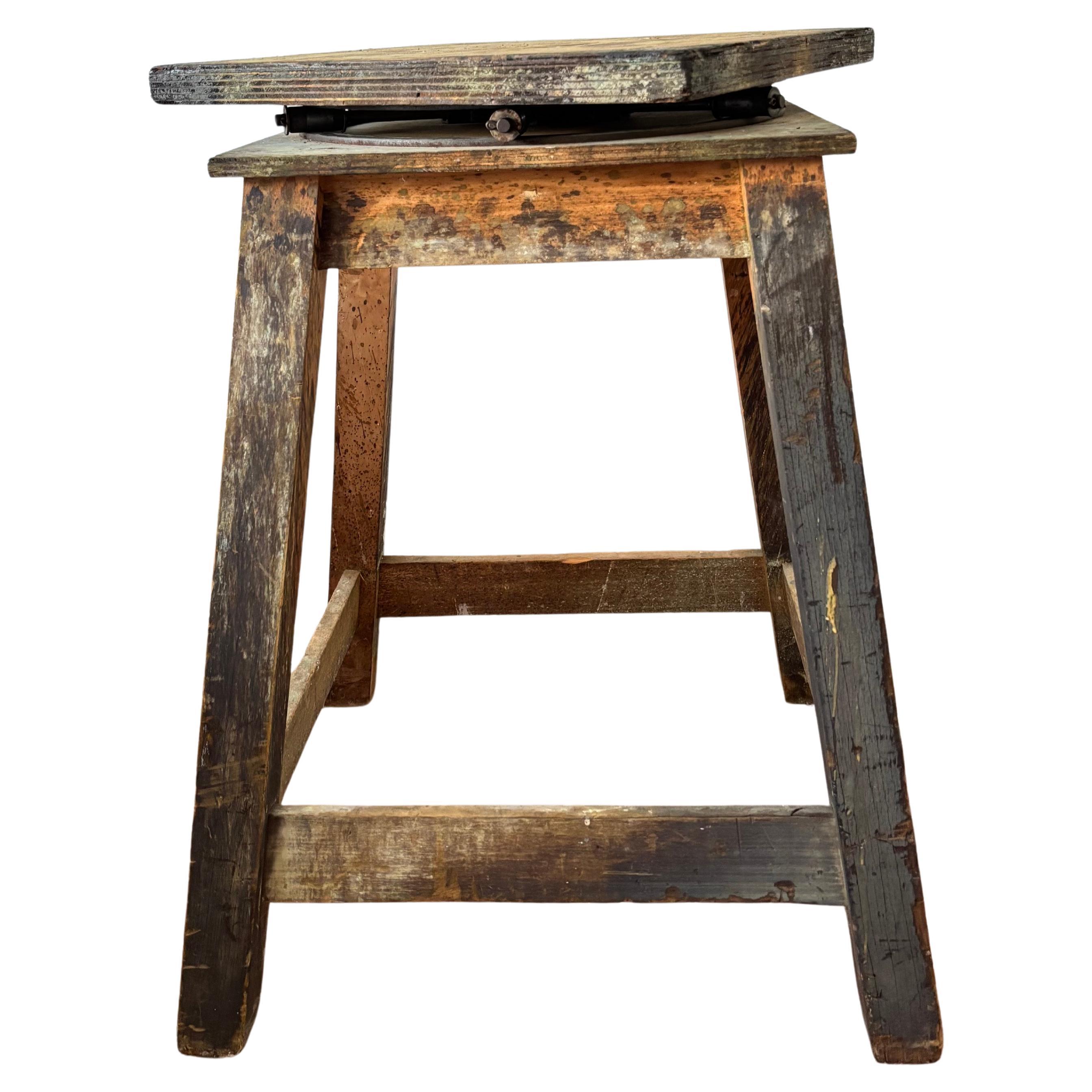 A monumental Sculptors studio stand of Architectural Form with rotating squared top. 

This solid and robust stand is made of patinated beechwood with a rather beautifully engineered metal rolling device to help the top rotate 360 degrees. This part