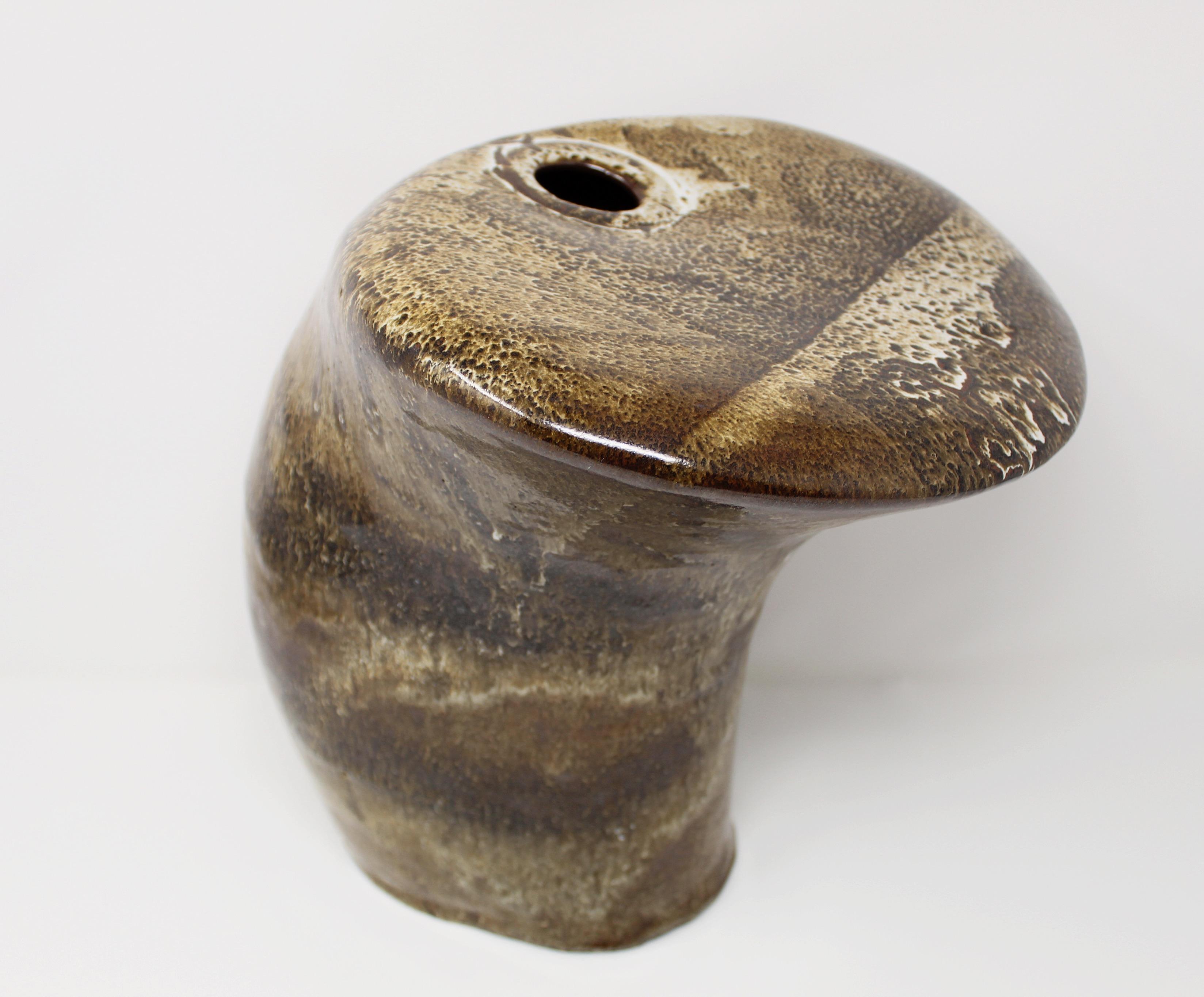 Mid-Century Modern sculptural pottery vase with abstract form. Handcrafted Brutalist vase has glaze finish with details in earth tone colors and subtle green hues. Sculpture has one opening and looks great from every angle.
   