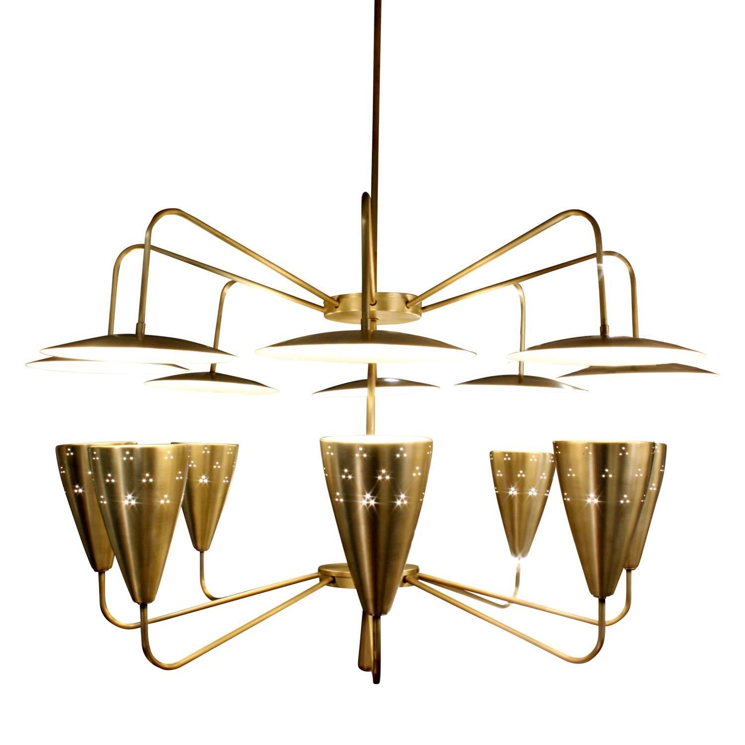 Large sculptural chandelier in satin brass with eight perforated shades facing lacquered reflectors by Northgate Lighting, American 1950s. This chandelier gives off a beautiful light.