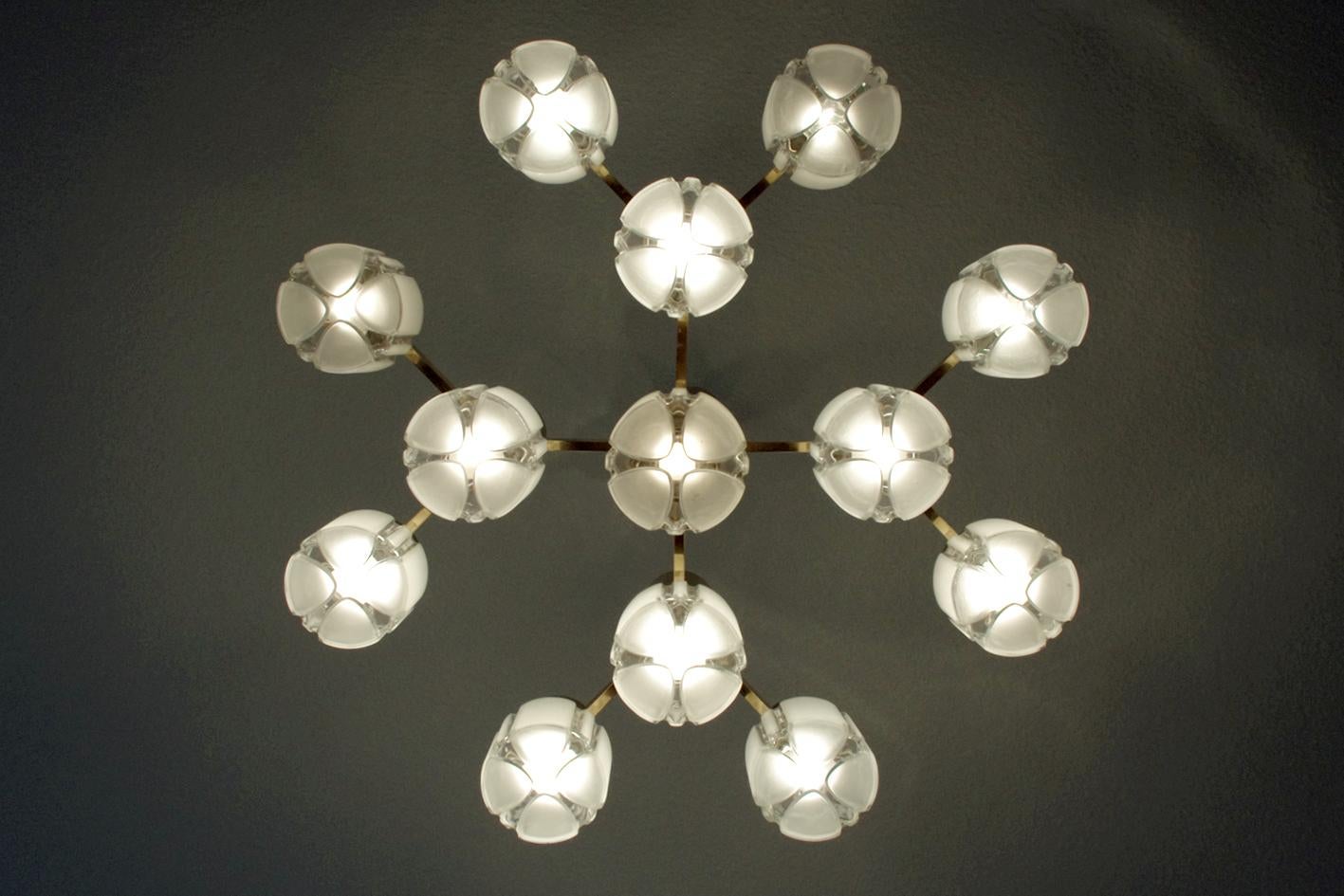 Spectacular vintage Sputnik chandelier (pendant or flush mount) with thirteen clear and matt glass shadows.
Germany, 1960s.
Measures: Diameter: 31.5 in, Height (body): 13.8 in.
Rod can be replaced as required for different height.
Lamp sockets: 13 x