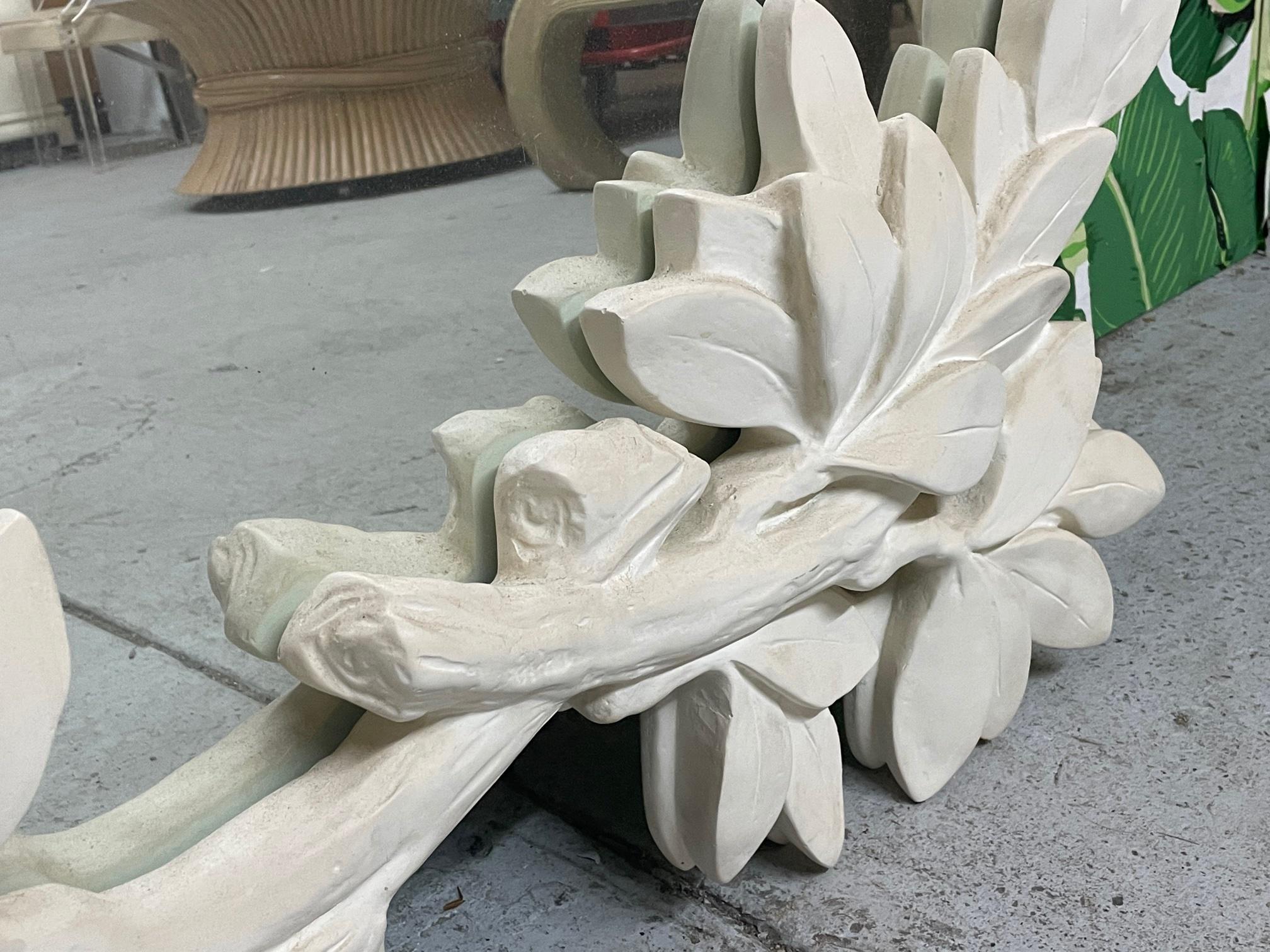 Large wall mirror in the manner of Dorothy Draper features sculptural vine and leaf motif and is constructed of molded heavy plaster. Very good condition with only very minor imperfections consistent with age.