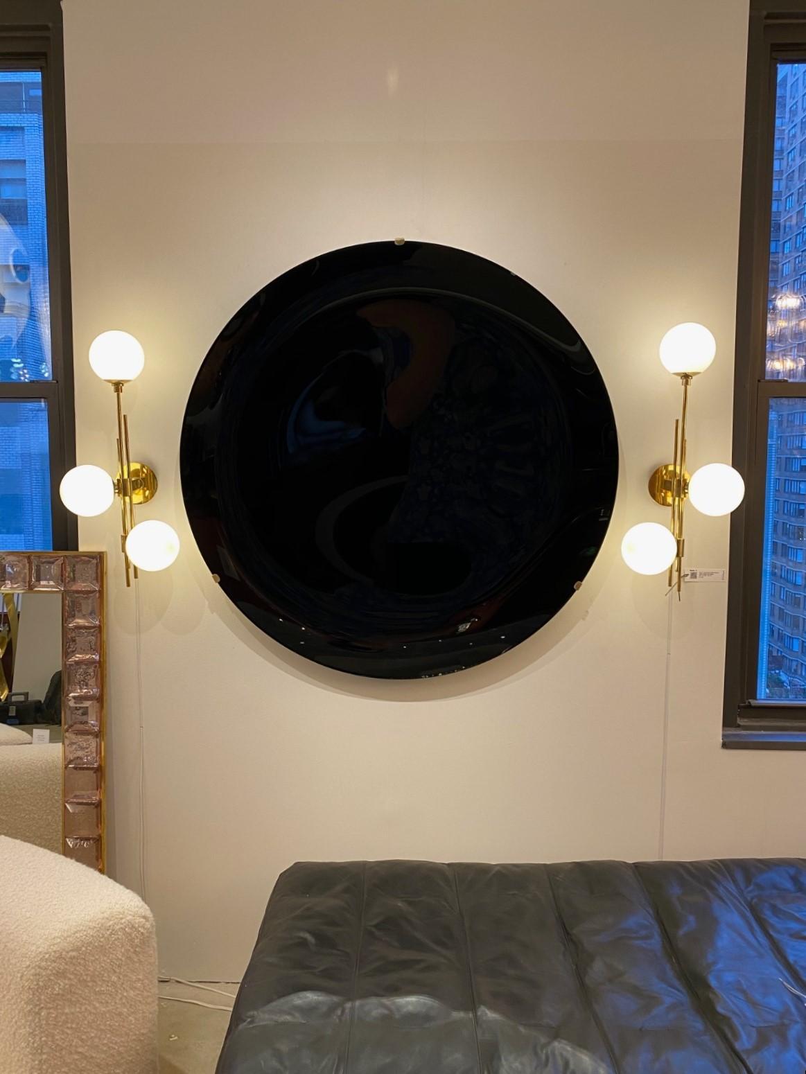 One of a kind, large sculptural round Black concave glass disc wall sculpture, Italy, 2023 reminiscent of an Andy Warhol pop art sculpture. Large round tinted glass in a dramatic Black hue, thermoformed into a sculptural concave form. Mounted on a