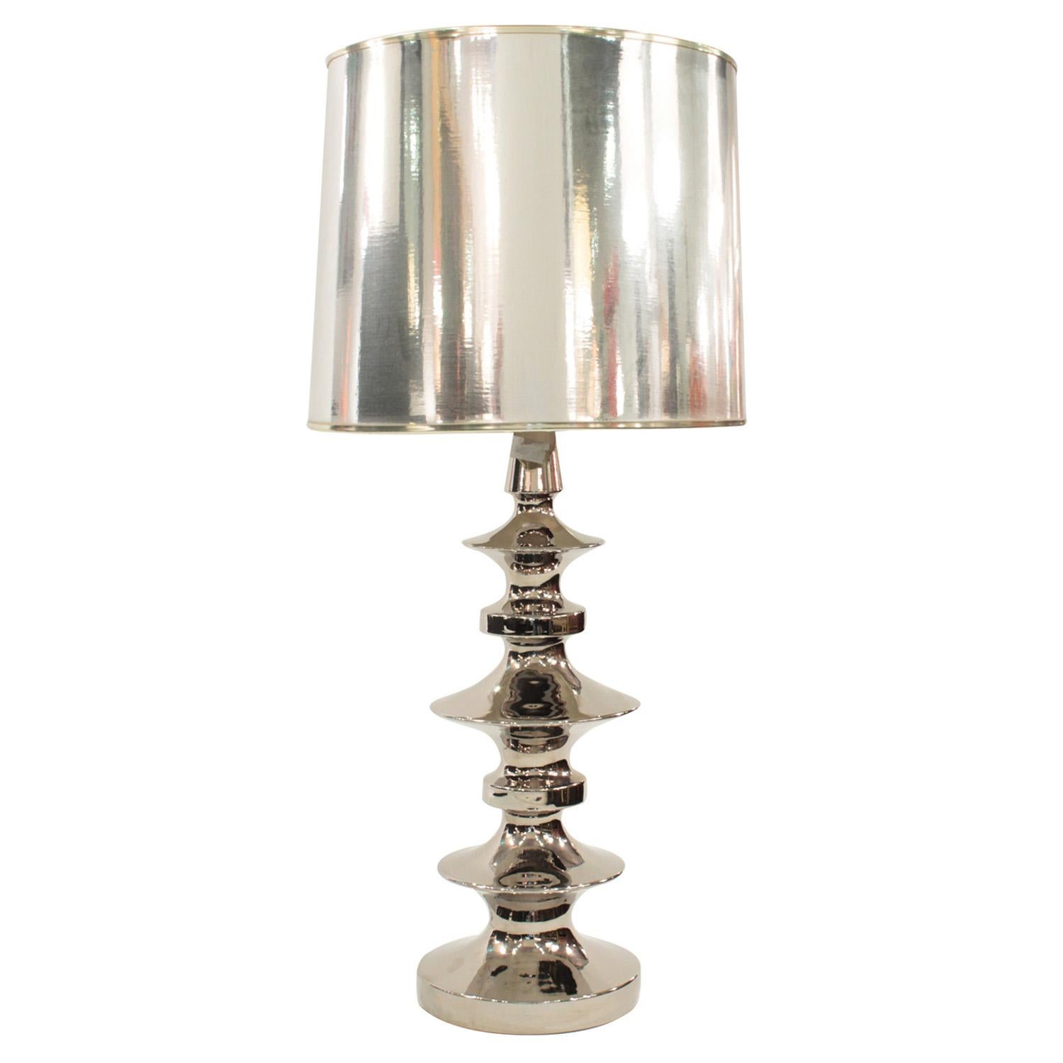 Large sculptural table lamp in nickel with reflective silver shade, American, 1970s.  This lamp is super stylish and would make add a wow factor to any room.