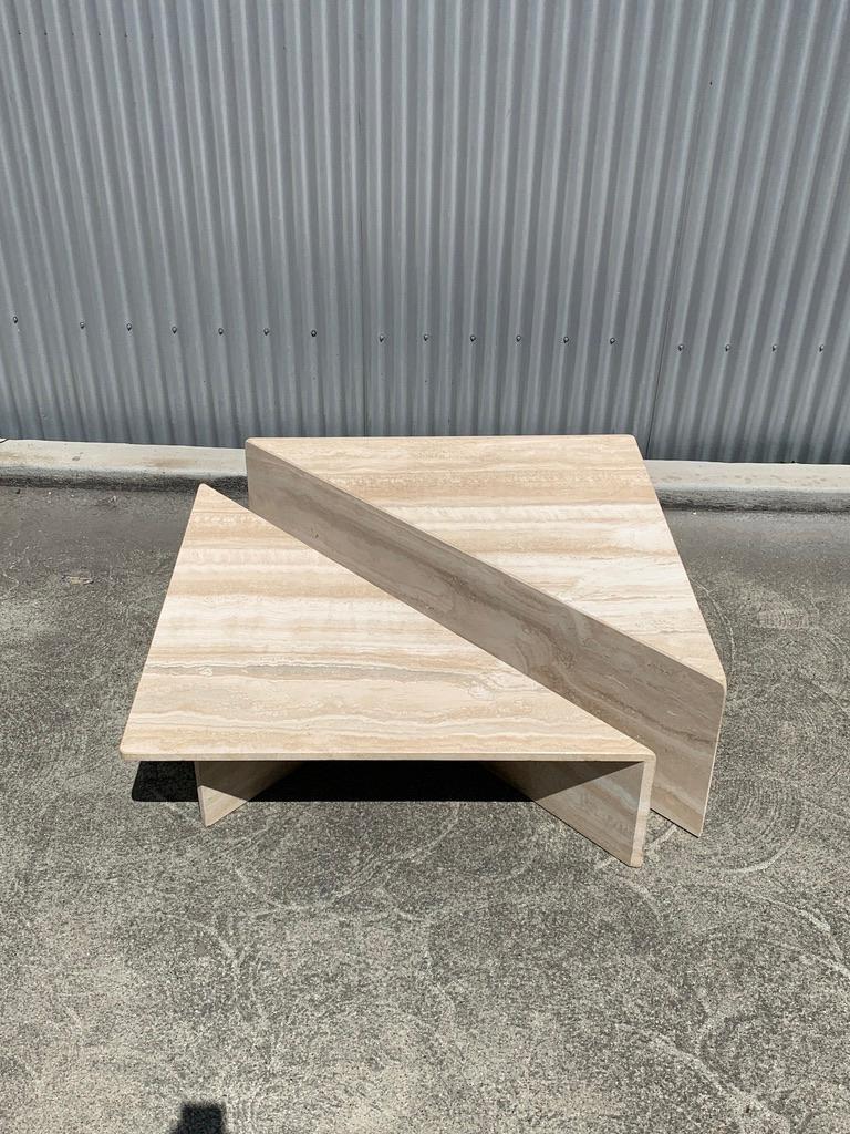 Fantastic sculptural two-piece, bi-level cocktail table in beautifully figured polished travertine. The table can be configured in a number of ways to compliment your seating with a super-chic 1970s vibe. All of the corners and joints are mitered