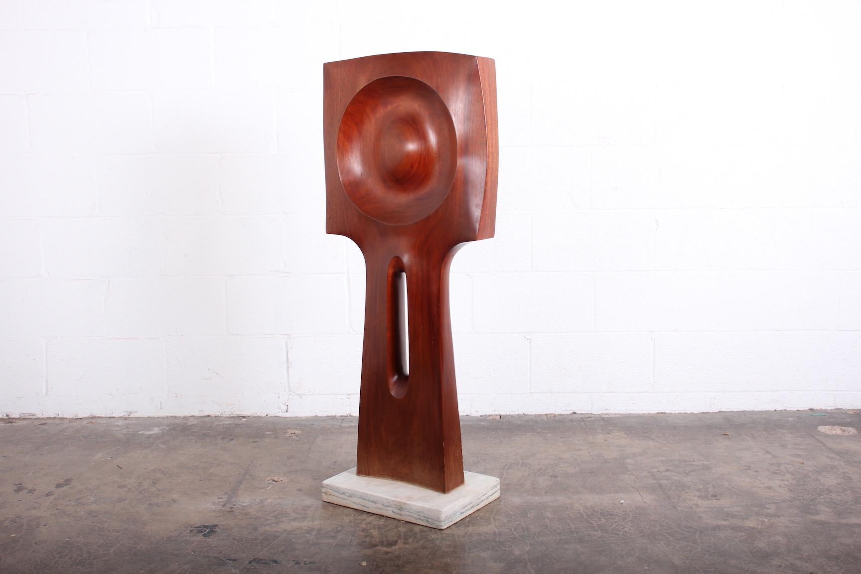 A large Henry Moretti mahogany sculpture on marble base, 1970's.