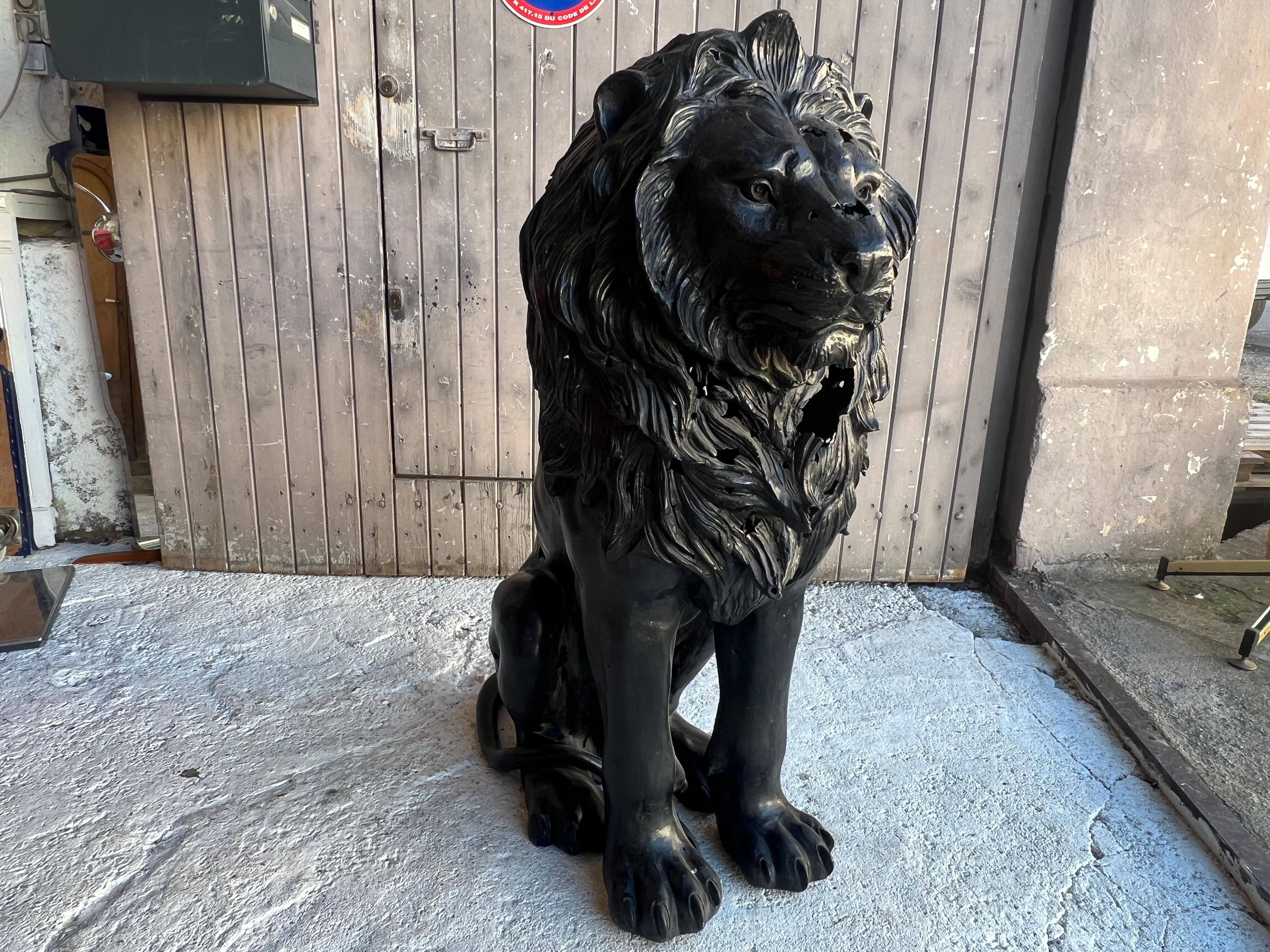  large bronze sculpture representing a seated lion
the bronze gives the effect of a sculpture emerging from the earth with its points of wear allowing interior lighting
the statue is really well made, the hair is very detailed, the line of the lion