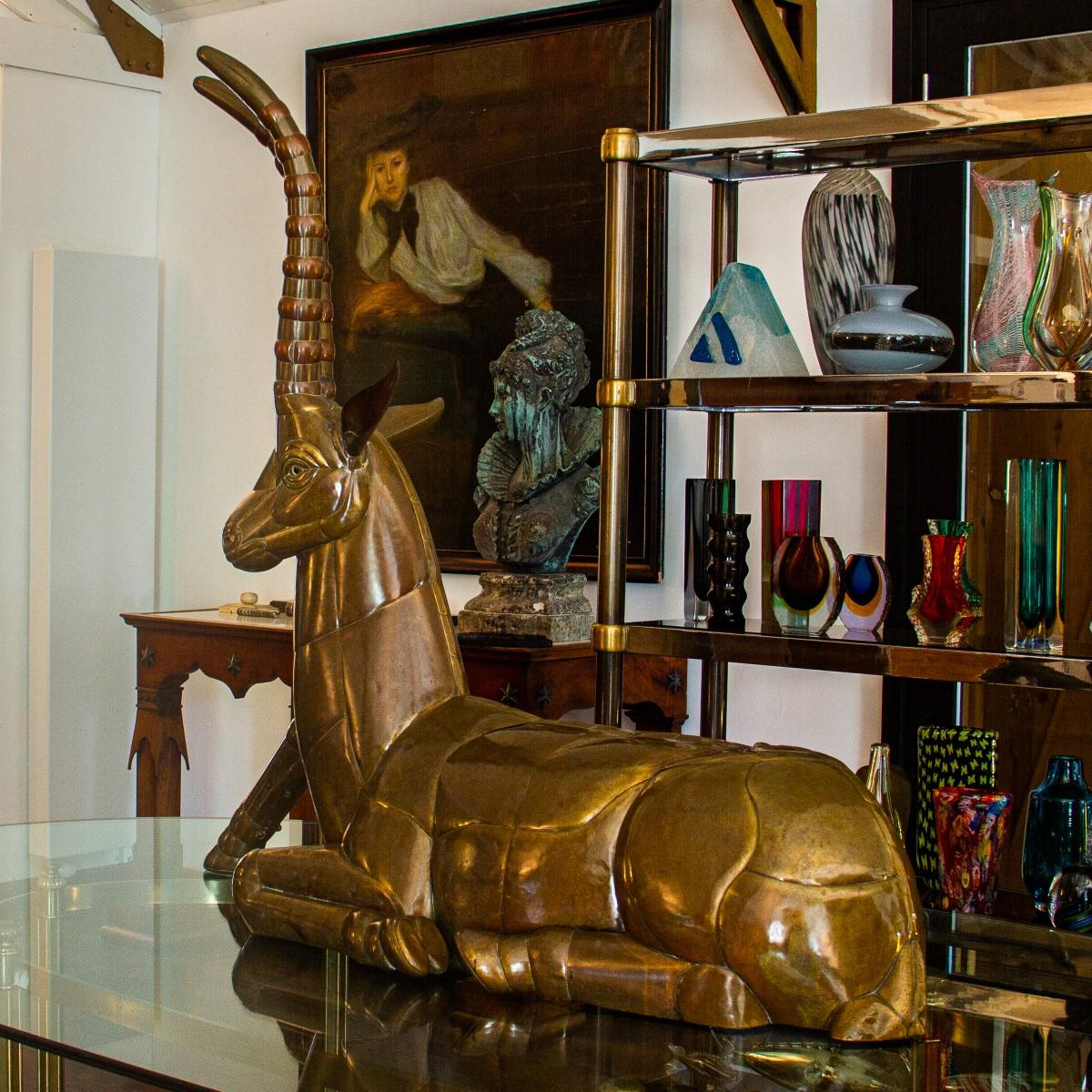 A large sculpture of a ibex in sheet brass and copper by the Mexican artist, Sergio Bustamante, 1970s. This ibex sculpture, comprised of mixed brass and copper, would work great in a within a variety of home interior styles, whether sitting