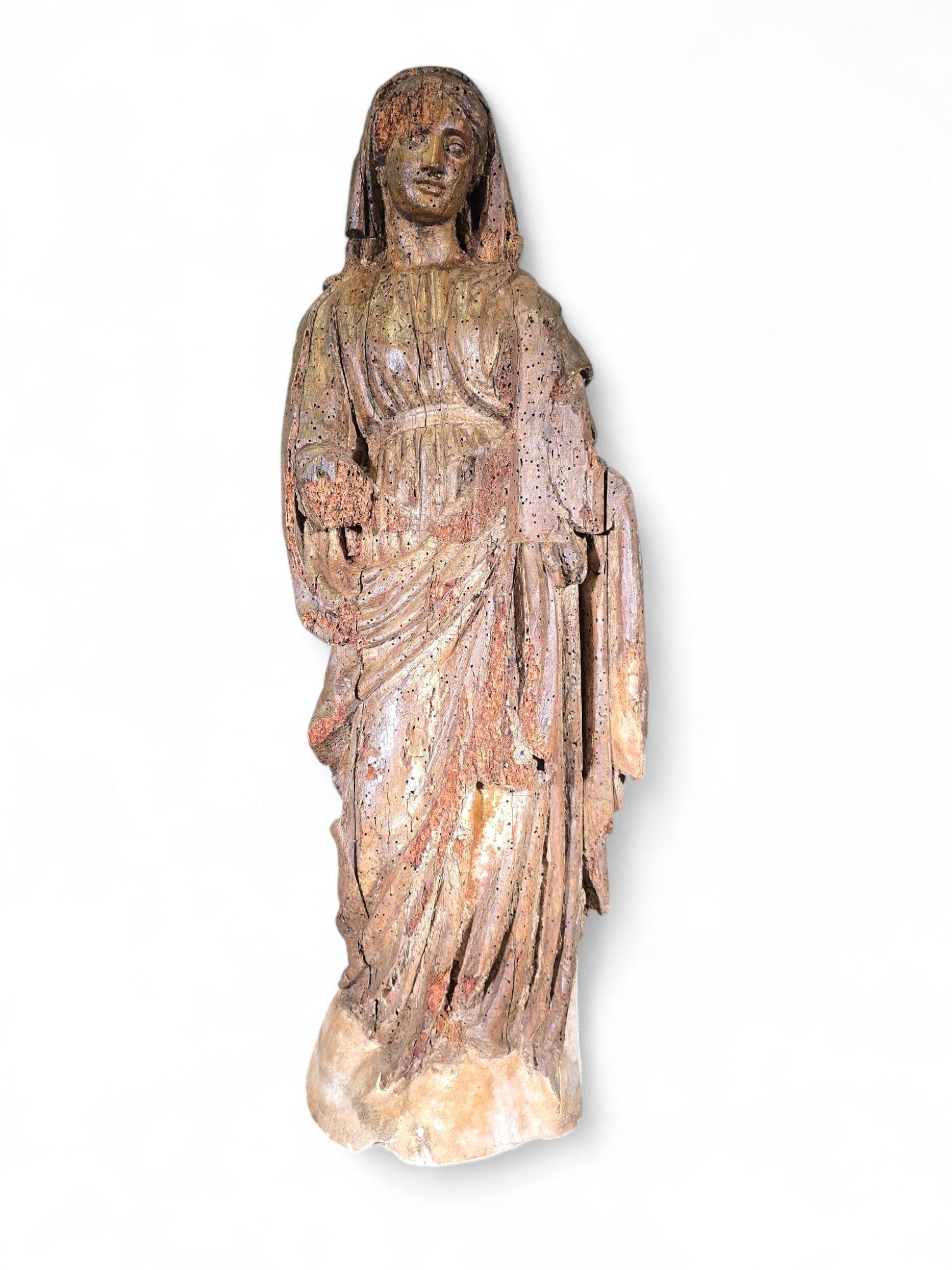 This majestic sculpture of the Virgin Mary, created in the 16 th century, is a unique piece of sacred art that stands out for its impressive detail and the beauty of its form. Crafted in wood with a patina that has withstood the test of time, this