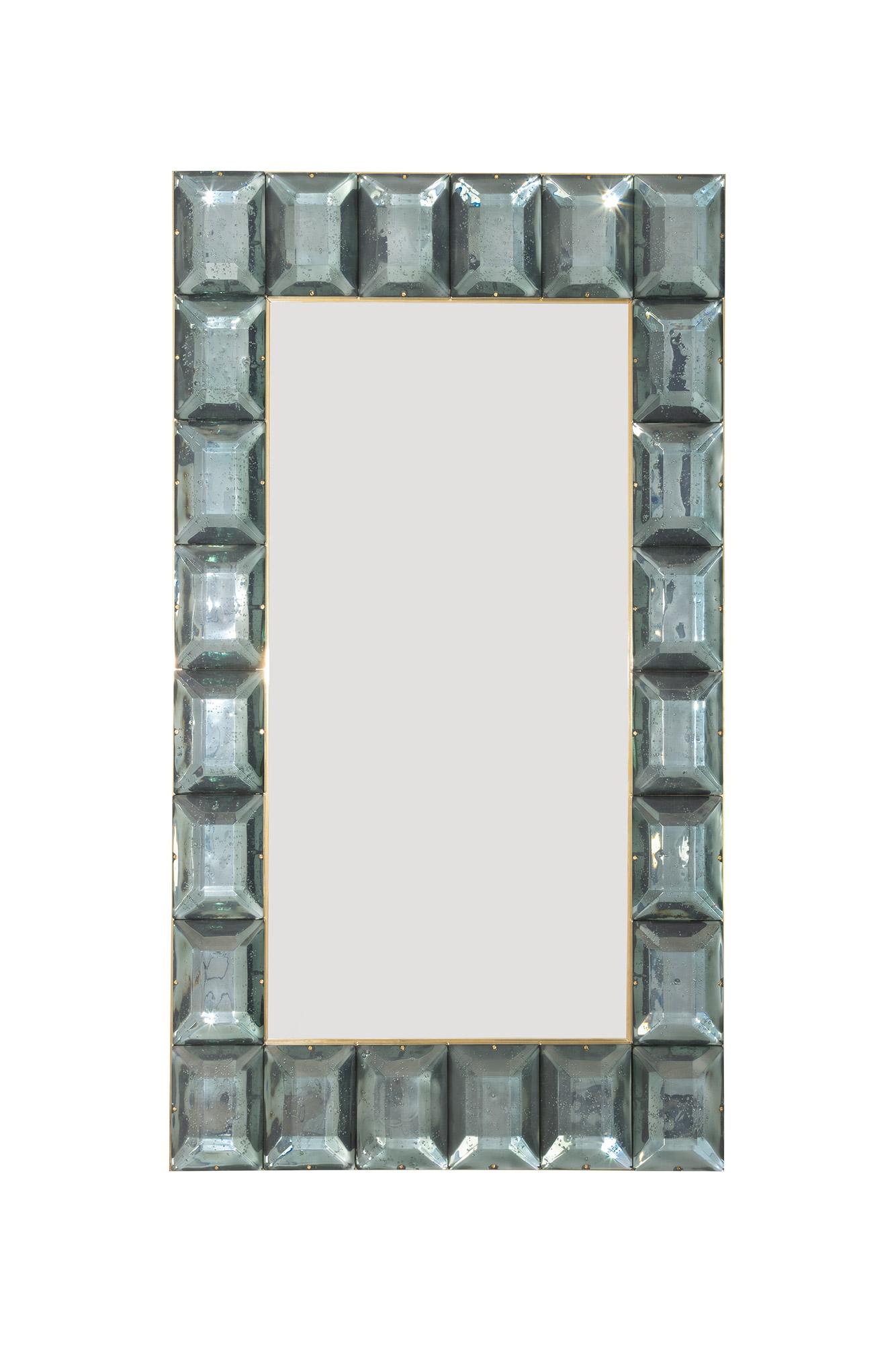 Large sea green aqua diamond cut Murano glass mirrors, in stock.
Contemporary and customizable mirror with a faceted sea green acqua Murano glass frame, edged in brass and luxury handcrafted by a team of artisans in Venice, Italy. Each pink glass