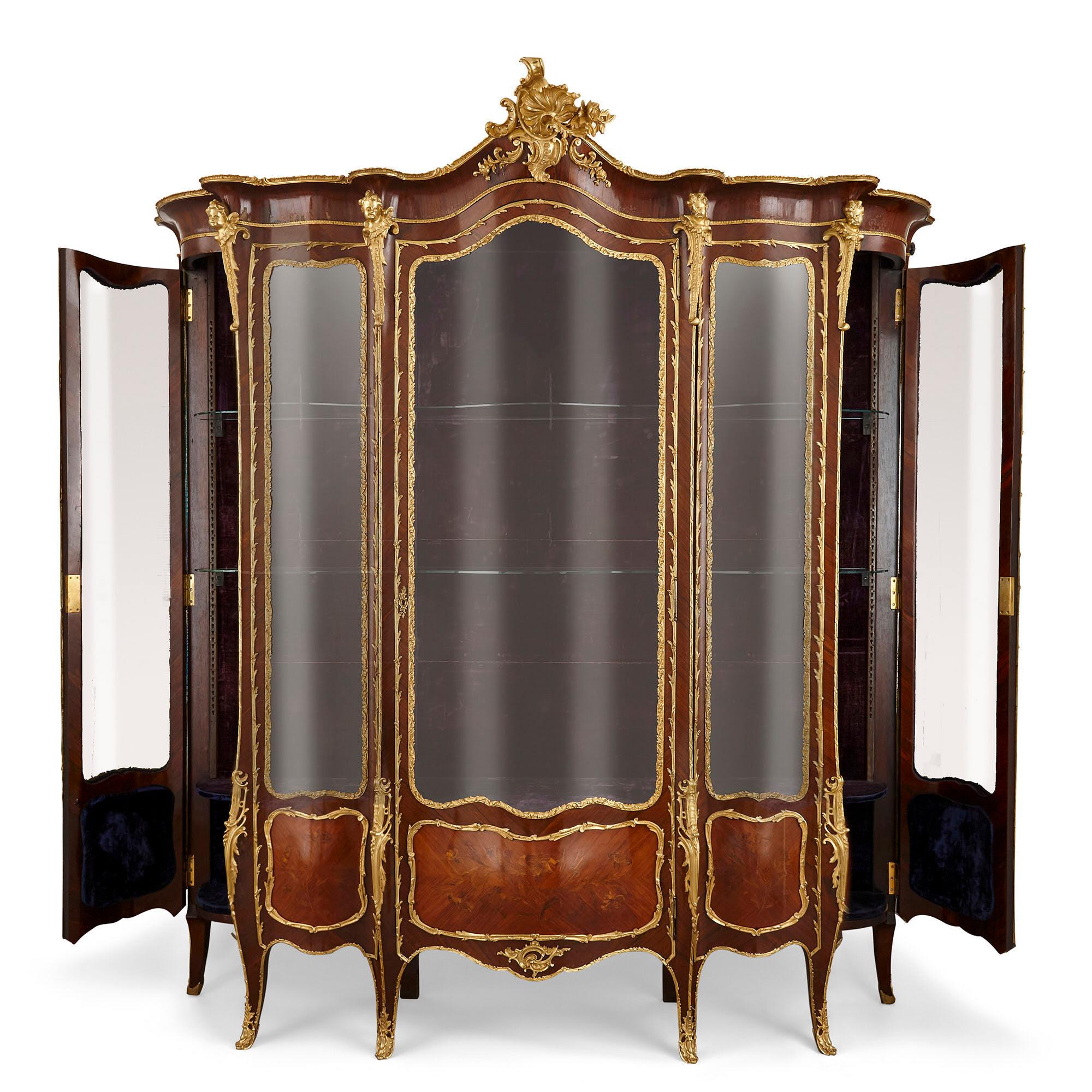 Large second Empire gilt bronze and marquetry display cabinet
French, late 19th Century
Measures: Height 271cm, width 235cm, depth 52cm

This magnificent display cabinet exemplifies the very best of the Second Empire style. The cabinet is
