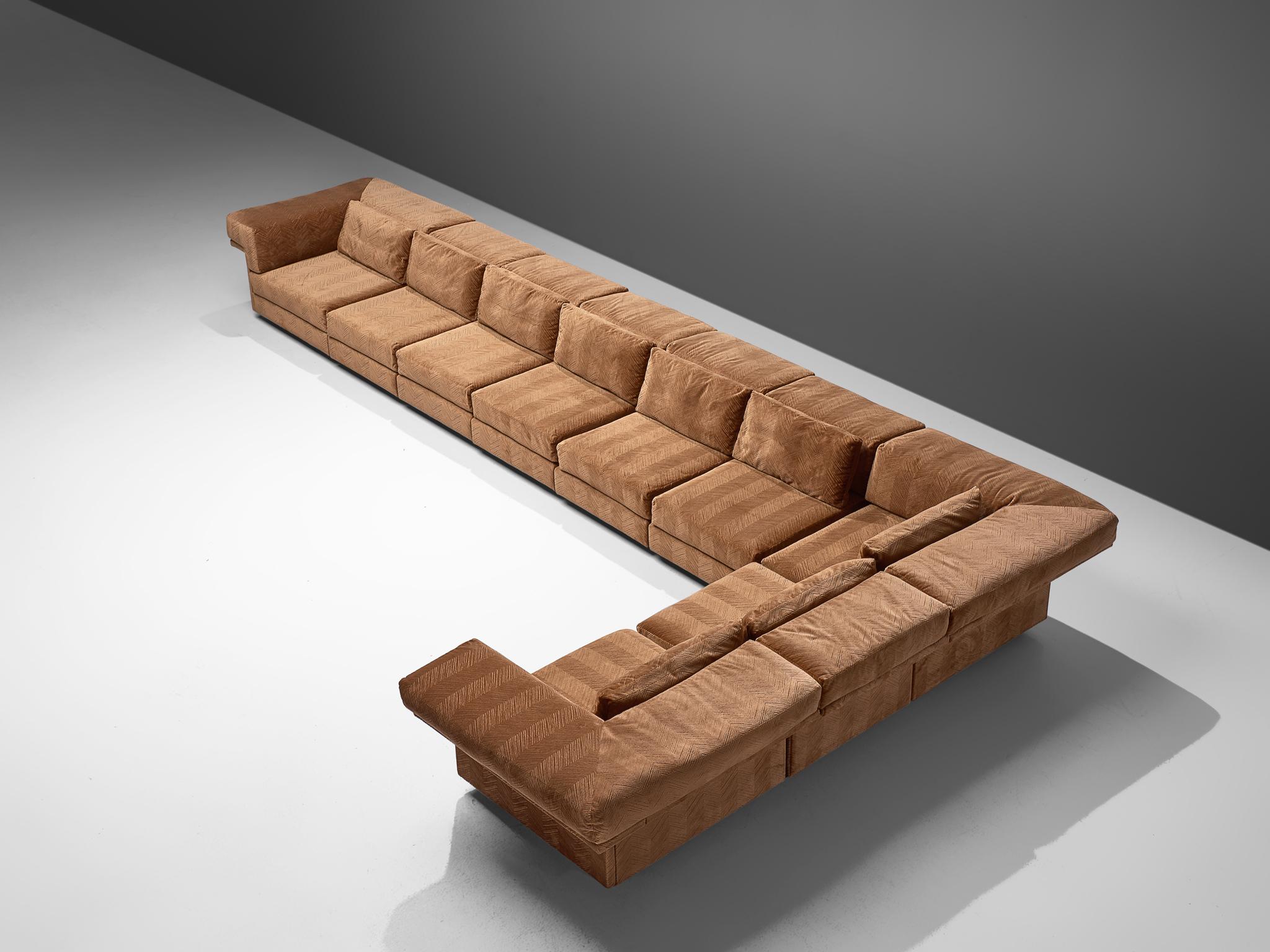 Sectional sofa, brown camel fabric, Germany, 1970s.

This extremely large sectional sofa contains three corner elements and seven straight elements, this makes it possible to arrange this sofa to your own wishes. The design is simplistic and