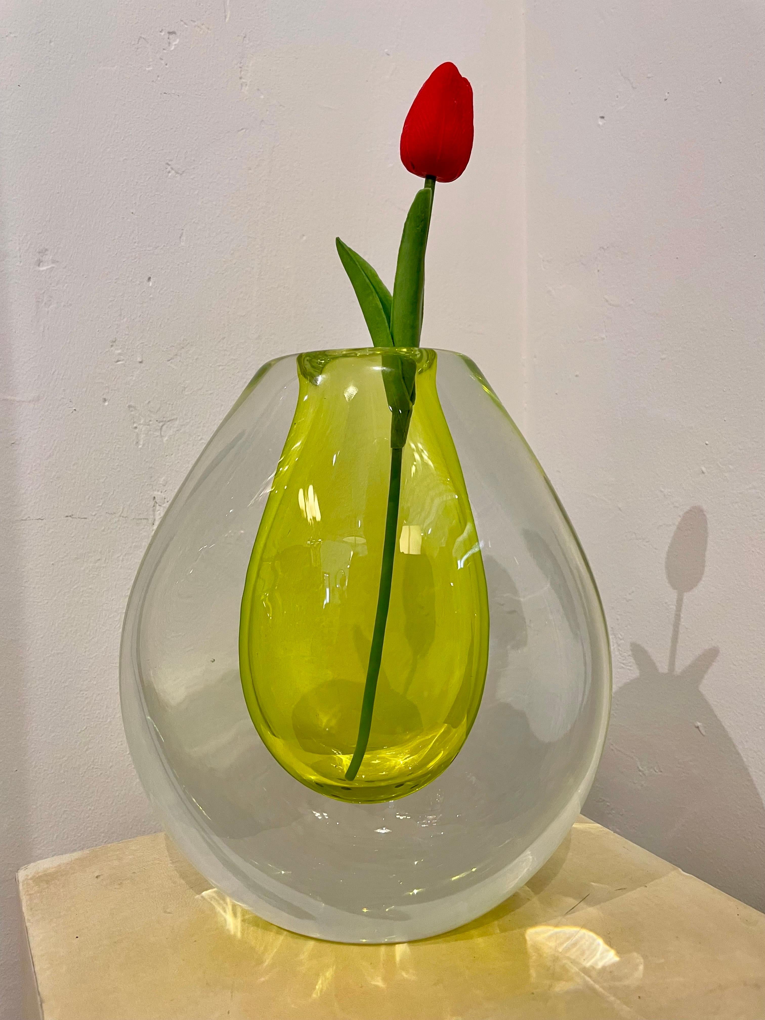 Made by Seguso for Poli, this incredible citron colored Murano glass floating inside a larger clear glass surround makes this large vase quite heavy. It is so vivid in color and beauty. Signed to bottom.