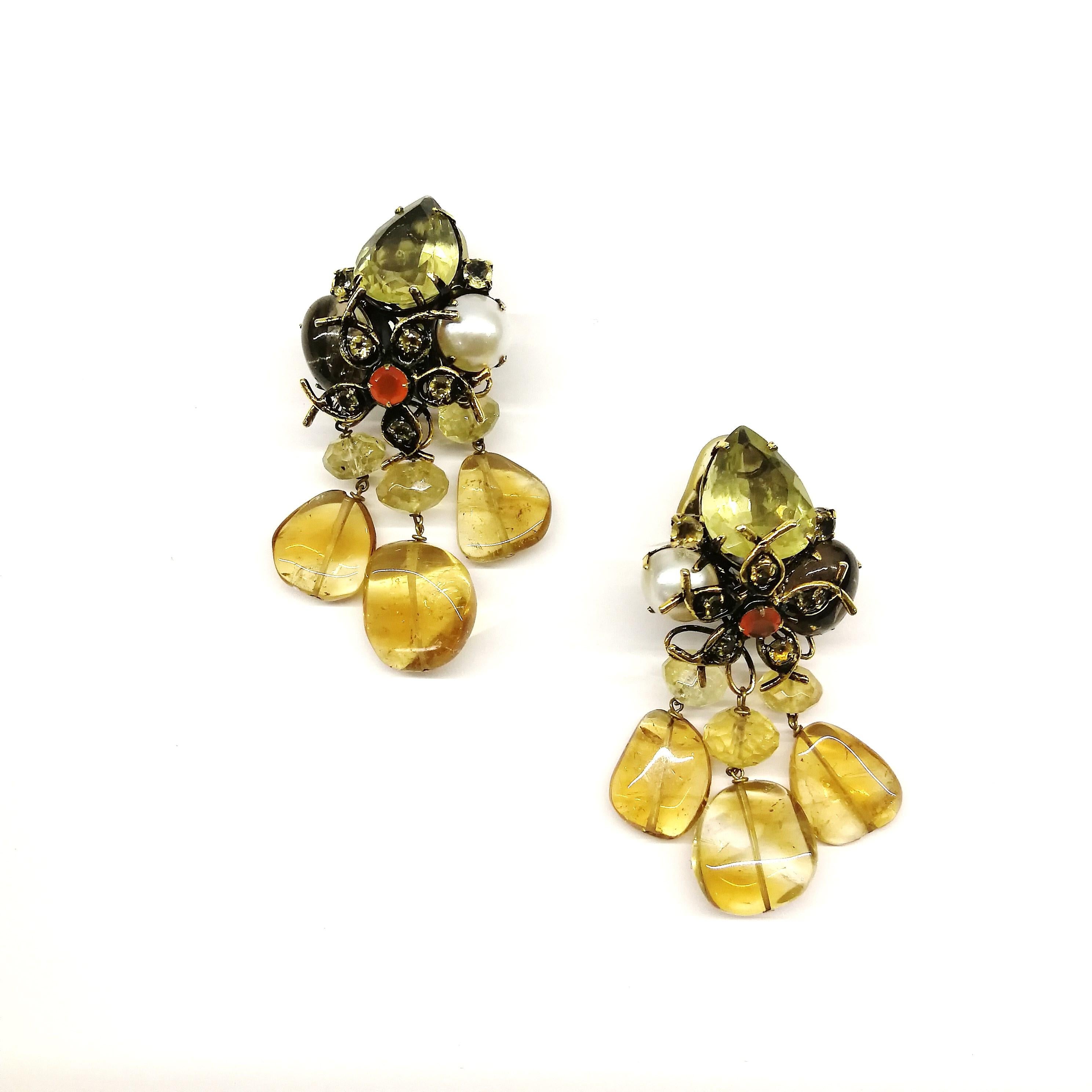 A gentle combination of colour mark these drop earrings from Iradj Moini in the 1990s. A soft colourway of citrine, cornelian, smokey quartz are highlighted by a cabuchon pearl, adding a richness to the combination. Iradj Moini earrings are always
