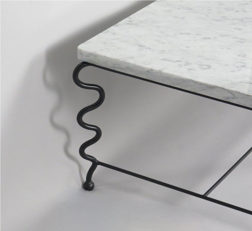 Contemporary hand-forged 'Serpentine' coffee table by Matthew Sidow.

Black wrought iron base with undulating legs and Carrara marble top. Each piece is handmade by our skilled artisans in the United States.

Please inquire for customization