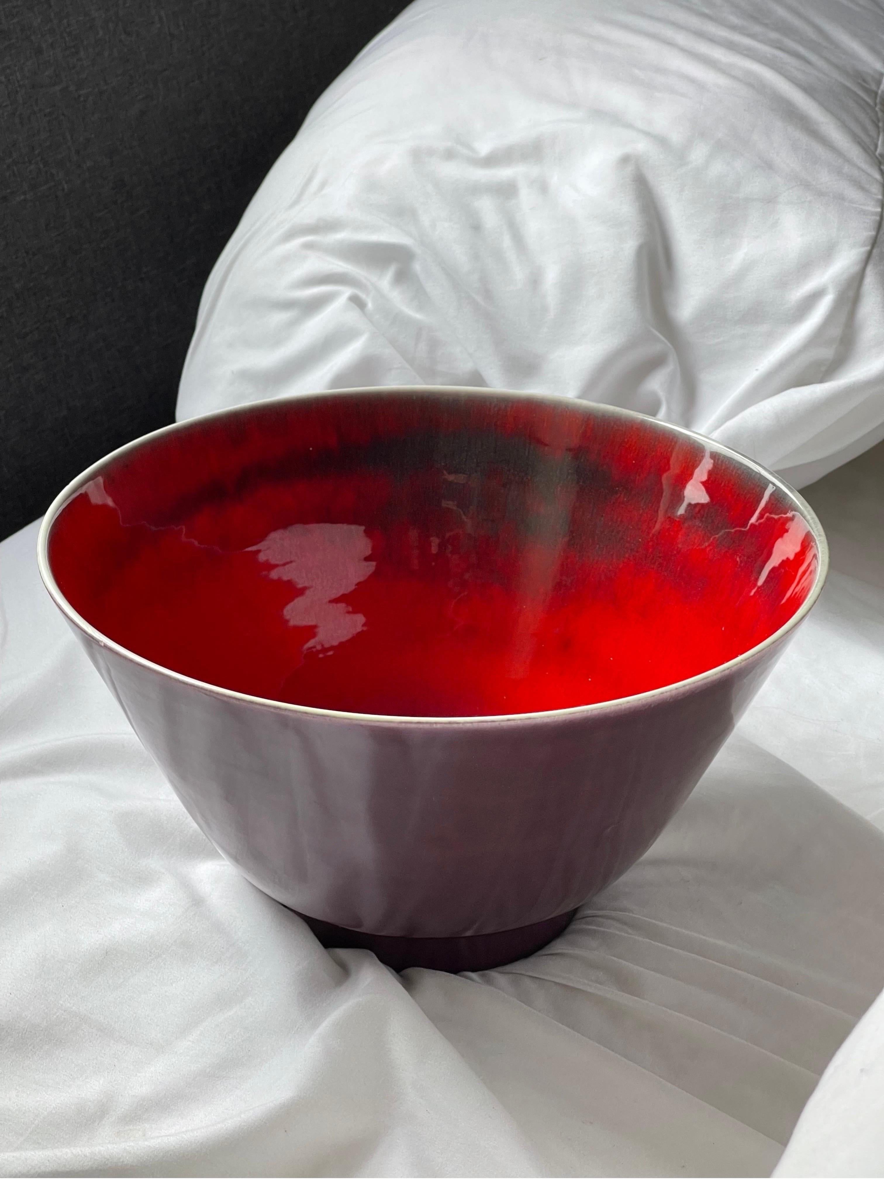 Striking purple and red large Italian Modernist ceramic bowl by Aldo Londi for Raymor. 1960’s. The fiery red inside companions well with the glossy purple glaze outside. 11.5” diameter x 6.5” tall. Signed.