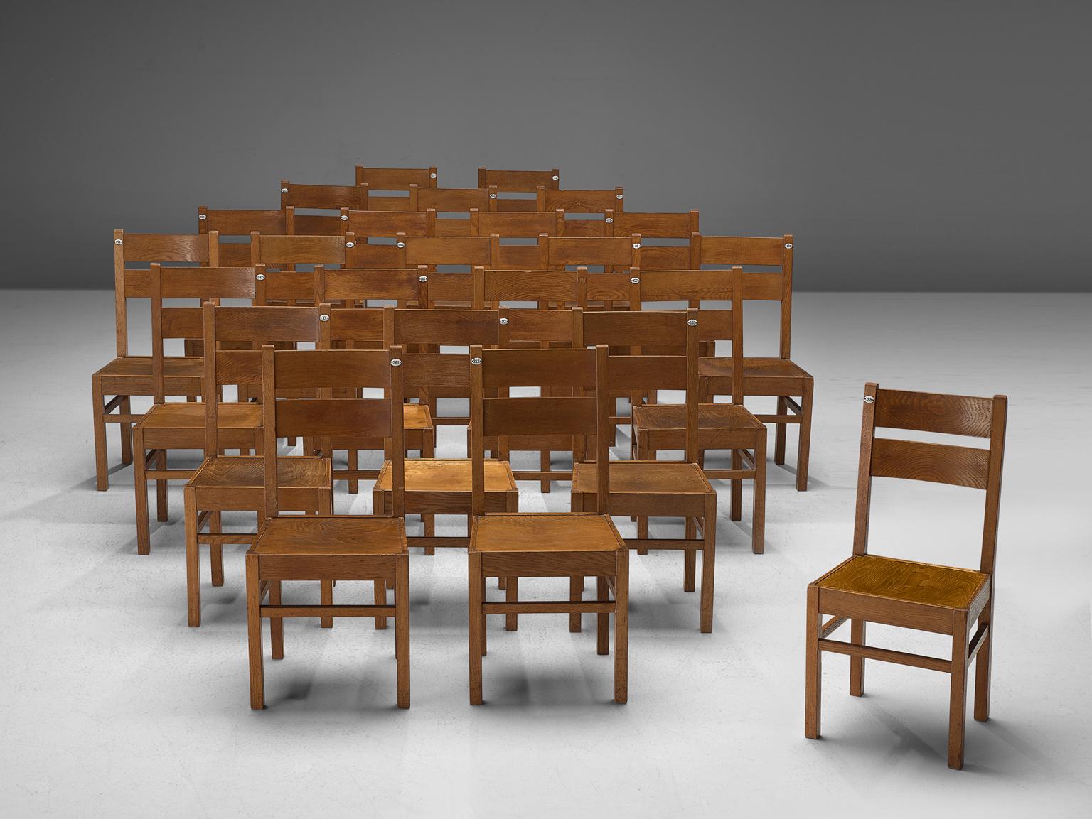 Large set of dining chairs, oak, France, 1960s.

Large set of chairs are executed in aged oak. The chairs have a very solid and geometric design with a straight backrest. The chairs are both functional and clear. Yet although the design might be