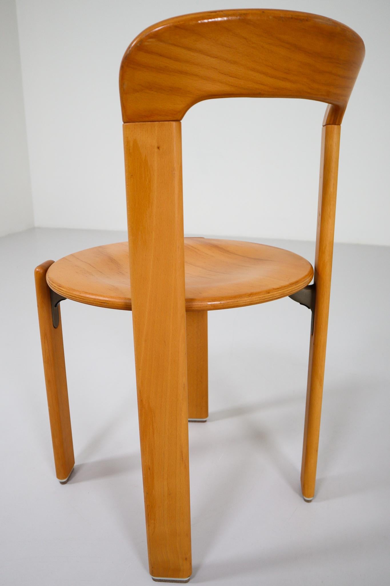 Large set dining room chairs were designed by Bruno Rey for Kusch and Co., 1970s. The dining room chairs were made of solid beech, laminated plywood beech and cast aluminum, characteristic steel brackets support wooden round seat. These chairs are