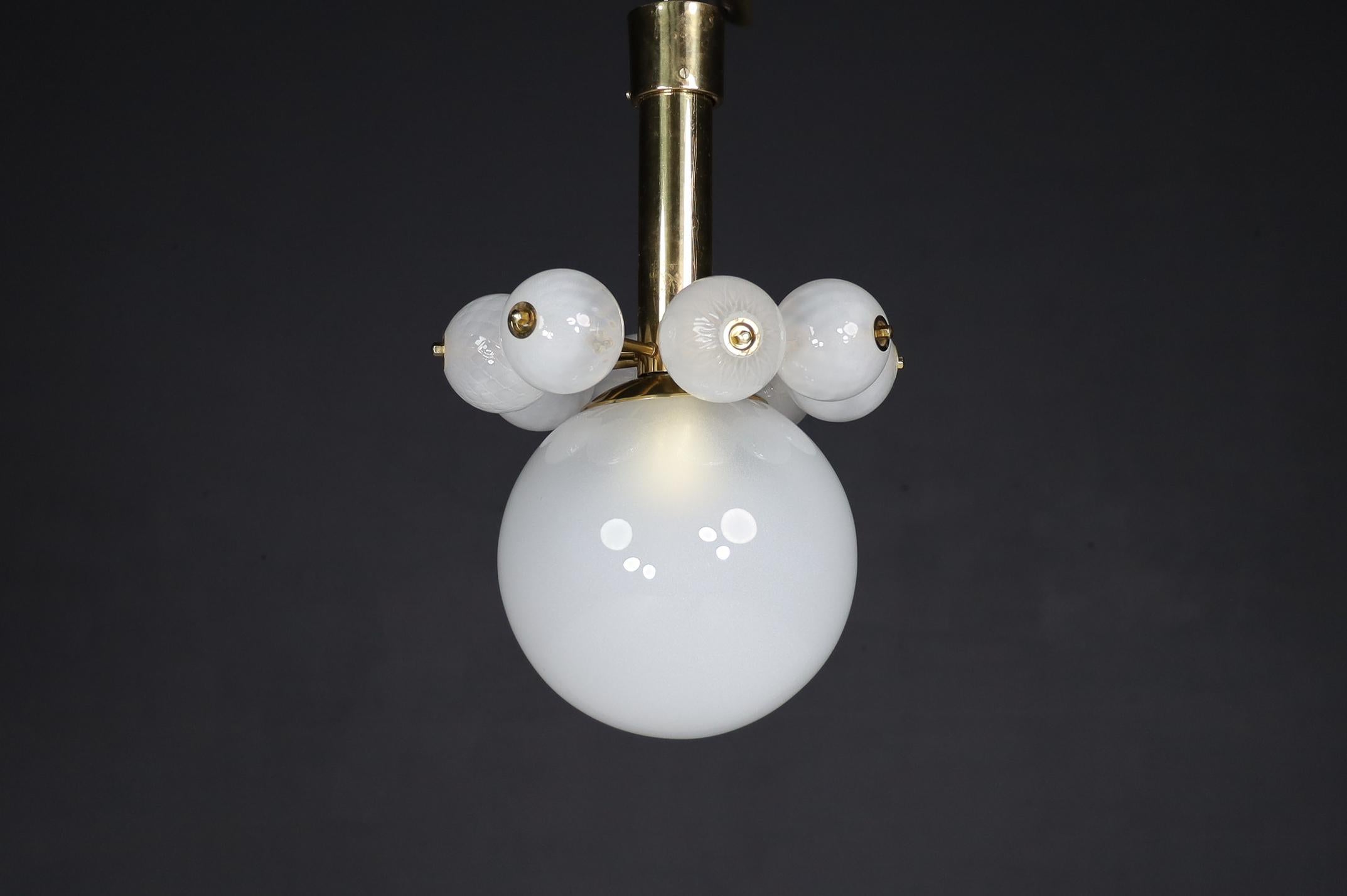 Large set chandelier with brass fixture and hand-blowed frosted glass globes, Czechia 1960s

An extensive set chandelier with a brass fixture was produced and designed in Czechia in the 1960s. A large frosted glass globe and eight smaller